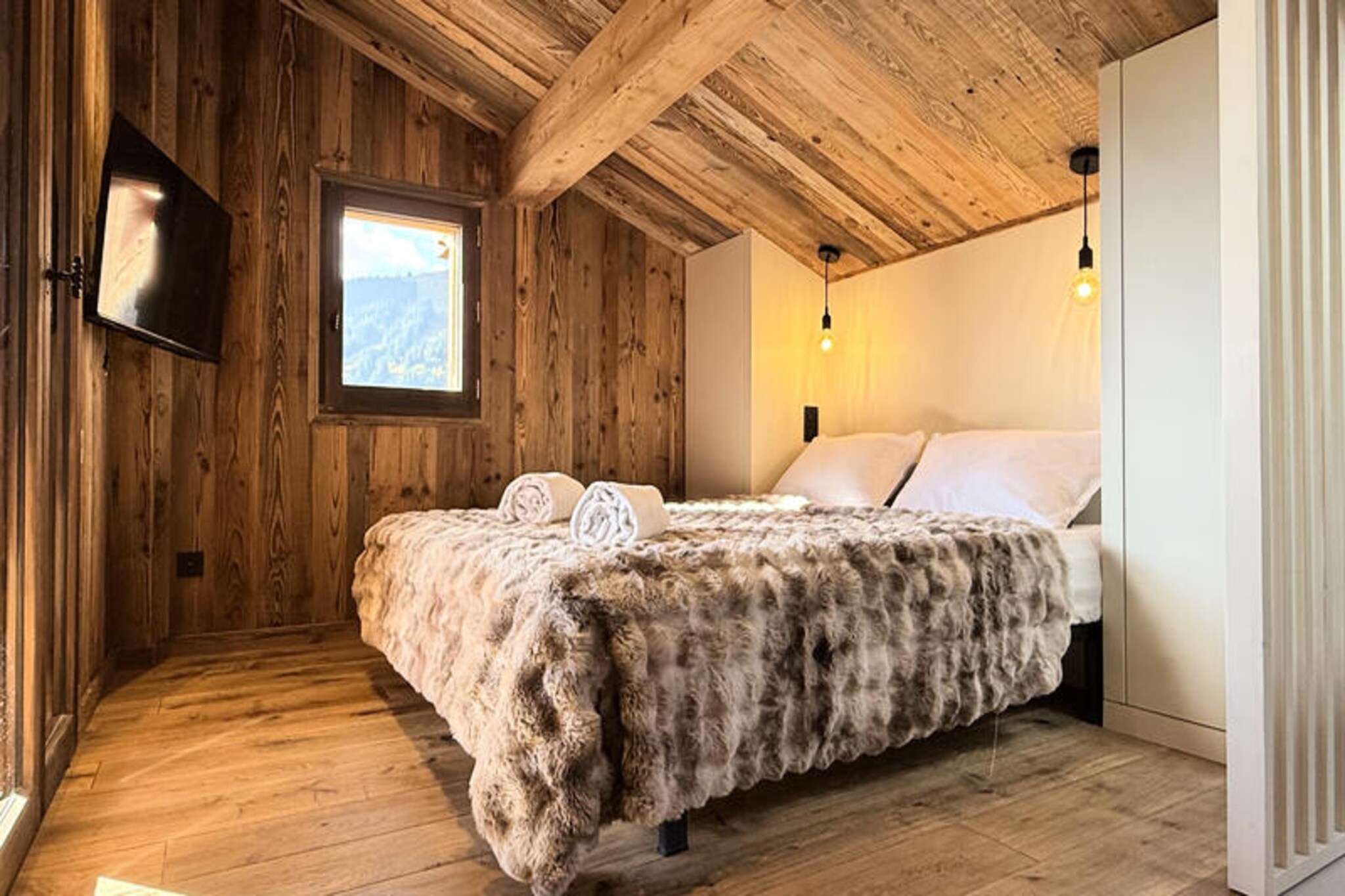 High above the picturesque village of Les Gets, Chalet Nova offers a serene alpine retreat where comfort meets breathtaking mountain views. Imagine mornings filled with crisp, fresh air as you step onto the expansive terrace, gazing out at the majestic Mont-Chéry. This chalet is not just a place to stay; it’s a haven for families and friends seeking a memorable escape in the French Alps. 
 
 Spanning 120 m² across three thoughtfully designed levels, Chalet Nova comfortably accommodates up to eight guests. The ground floor welcomes you with a warm living area featuring a wood-burning fireplace, a fully equipped open-plan kitchen, and a dining room with panoramic views. Upstairs, you’ll find cozy bedrooms, each with its own en-suite shower area, ensuring privacy and relaxation. The lower floor is a hub of entertainment and wellness, boasting a ski room, a games lounge, and a luxurious Jacuzzi for unwinding after a day on the slopes. Modern amenities such as Wi-Fi, a laundry room, and ample storage make your stay seamless and stress-free.
 
 Conveniently located on the sought-after Route des Chavannes, the chalet is just a 6-minute drive from the main ski lifts and schools, and a 5-minute drive from the charming village center. A bus stop only 250 meters away ensures easy access to the area’s attractions. Whether you’re skiing in winter or exploring the lush trails in summer, Chalet Nova’s location is perfect for adventurers and nature lovers alike.
 
 With its blend of modern comfort and alpine charm, Chalet Nova promises a rejuvenating holiday experience. From the crackling fireplace to the inviting Jacuzzi, every detail has been designed to create lasting memories. Book your stay and discover the magic of Les Gets in every season.