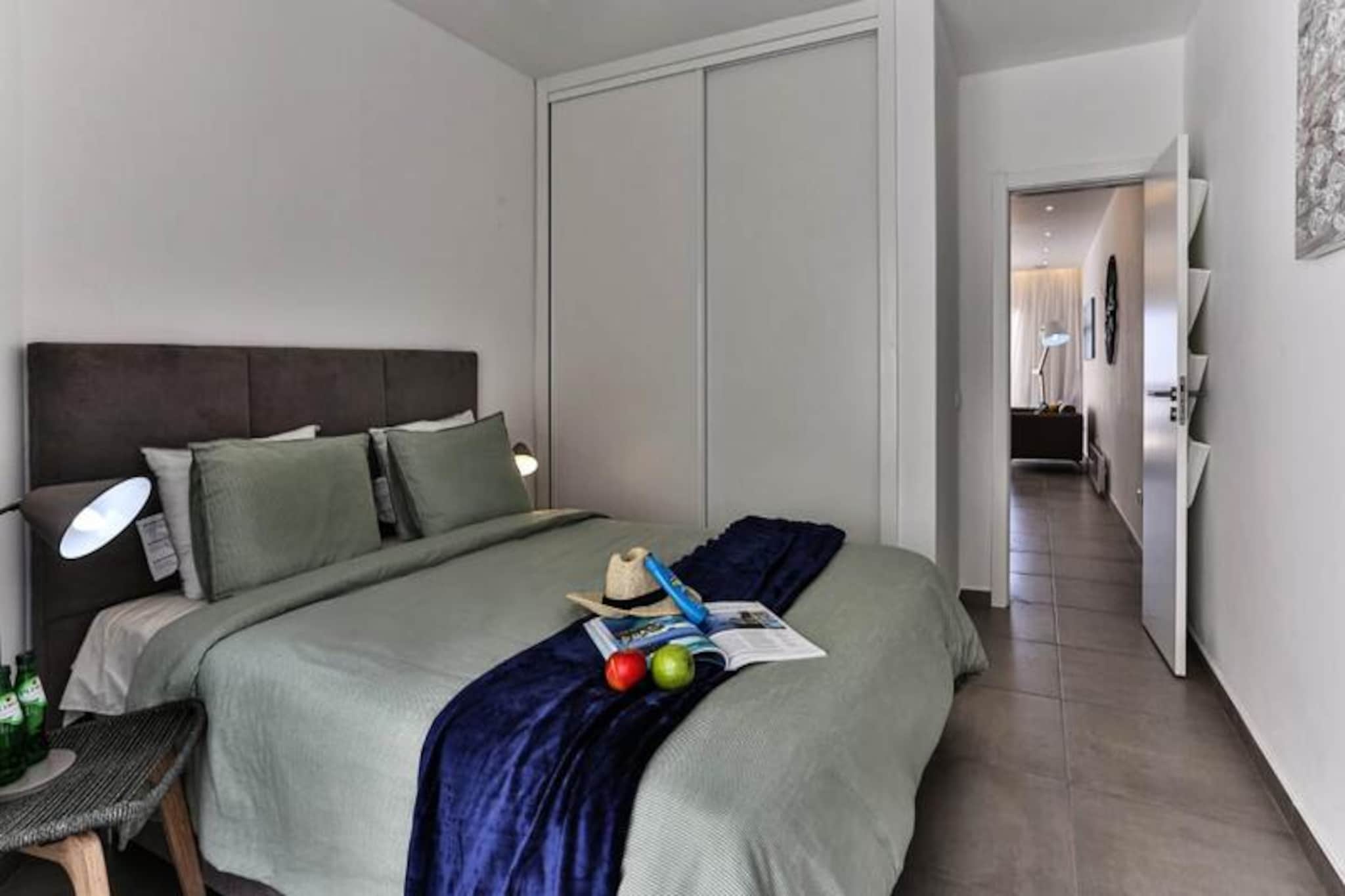 Awaken your senses in the serene coastal town of Luz, where Lemon Tree Apartment offers a tranquil escape just a stone’s throw from the beach. Imagine starting your mornings with the gentle sound of waves and the scent of salty sea air, as you sip your coffee on the patio overlooking the sparkling ocean. This modern one-bedroom apartment is a haven of relaxation, perfect for couples or small families seeking a peaceful retreat along the Algarve coast.
Step inside to discover a bright and airy space, thoughtfully designed with comfort and style in mind. The open-plan kitchen and living area are bathed in natural light streaming through French doors, creating a seamless connection to the outdoors. The bedroom features a plush king-size bed, while the spacious walk-in shower adds a touch of luxury to your stay. For added convenience, the apartment is equipped with Wi-Fi, a smart TV with Netflix, a washing machine, and a small storage area. Two folding stools are available for young children, ensuring flexibility for families.
Just a 2-minute stroll brings you to Luz’s golden, child-friendly beach, ideal for swimming, surfing, or simply soaking up the sun. The town itself is brimming with charm, offering a delightful mix of shops, bars, and restaurants, all within walking distance. Venture further to explore the dramatic cliffs, hidden coves, and scenic hiking trails that define this stunning region. For a taste of vibrant city life, Lagos is only a 15-minute drive away, boasting a historic center, marina, and a wealth of activities.
Whether you’re here to unwind by the sea, embark on coastal adventures, or savor the Algarve’s culinary delights, Lemon Tree Apartment is your perfect home away from home. Book now and let the beauty of Luz captivate you.