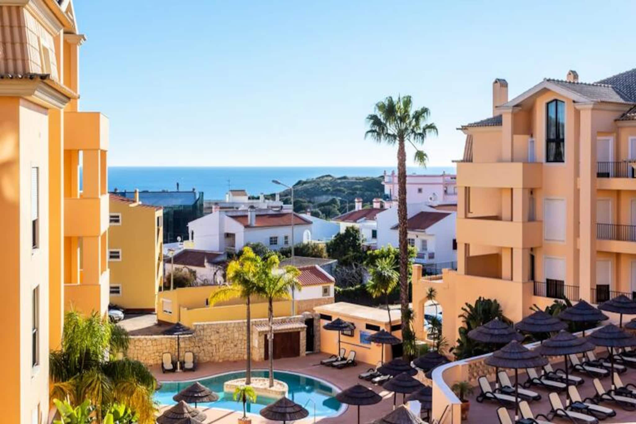 Wake up to the sound of gentle waves and the warmth of the Algarve sun in this charming one-bedroom apartment, perfectly situated in the heart of Praia da Luz. Just a short stroll from the golden sands and the vibrant village center, this property offers the ideal retreat for couples or small families seeking a relaxing getaway by the sea. The picturesque surroundings, with their dramatic cliffs and serene ocean views, set the stage for unforgettable holiday memories. 

Inside, the apartment is bright and modern, featuring a spacious bedroom with a comfortable double bed, a sleek bathroom with a bathtub, and a fully equipped kitchen for preparing delicious meals. The private balcony invites you to start your mornings with a coffee while soaking in the views or unwind in the evening with a glass of local wine. Guests also have access to the complex's outdoor swimming pools, including a heated pool available seasonally, as well as a year-round indoor pool and a gym, ensuring relaxation and leisure at your fingertips. 

Praia da Luz is a gem on the Algarve coast, offering a blend of tranquil beach days and exciting activities. Explore the nearby cliffs, take a refreshing swim, or try your hand at surfing. The historic town of Lagos, just a 10-minute drive away, is a must-visit, with its cobbled streets, vibrant marina, and stunning coastal caves best explored by boat or kayak. Whether you’re here to relax or seek adventure, this location has it all. 

Make this apartment your home away from home and experience the beauty and charm of the Algarve. With its unbeatable location, modern amenities, and warm hospitality, it’s the perfect base for your next holiday.