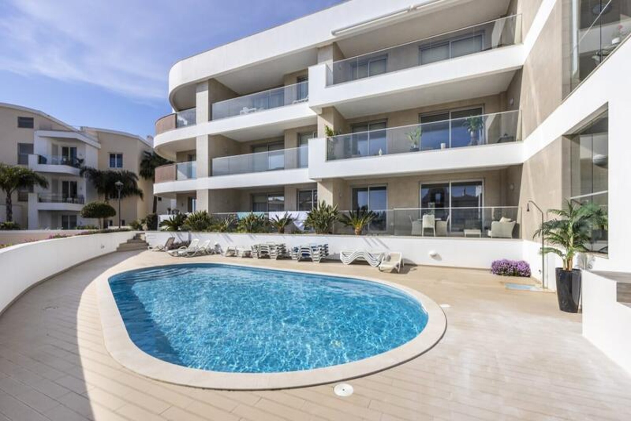 A short stroll from the golden sands of Porto de Mós beach, this elegant ground-floor apartment in Lagos offers a serene retreat for your Algarve getaway. Nestled within an exclusive condominium of just twelve apartments, it combines privacy, comfort, and convenience, making it the perfect choice for families, couples, or small groups seeking a luxurious escape. The tranquil surroundings and beautifully landscaped gardens create an inviting atmosphere for relaxation and leisure. 
 
 Step inside this bright and spacious two-bedroom, two-bathroom apartment, where every detail has been thoughtfully designed for your comfort. The master bedroom features a plush king-size bed and an en-suite bathroom with a Jacuzzi bathtub, while the second bedroom offers two single beds that can be converted into a double. A separate shower room ensures added convenience. The fully equipped kitchen includes modern appliances such as a dishwasher, washing machine, and ceramic hob, making it easy to prepare meals to enjoy in the open-plan dining area or on the south-facing balcony overlooking the pool and partial sea views. The apartment is fully air-conditioned, ensuring a pleasant stay year-round.
 
 The condominium provides access to a shared rooftop terrace and a pool surrounded by sun loungers, perfect for soaking up the Algarve sun. Just a 10-minute walk away, Porto de Mós beach awaits with its crystal-clear waters and beachfront restaurants, while the historic center of Lagos is a short drive or bus ride away. Explore the cobbled streets, vibrant nightlife, and rich history of this charming coastal town, or venture further to discover water parks, hiking trails, and world-class golf courses.
 
 With Faro Airport just an hour’s drive away and excellent transport links, this apartment is your gateway to the best of the Algarve. Whether you’re seeking adventure, culture, or pure relaxation, this property offers an unforgettable holiday experience.