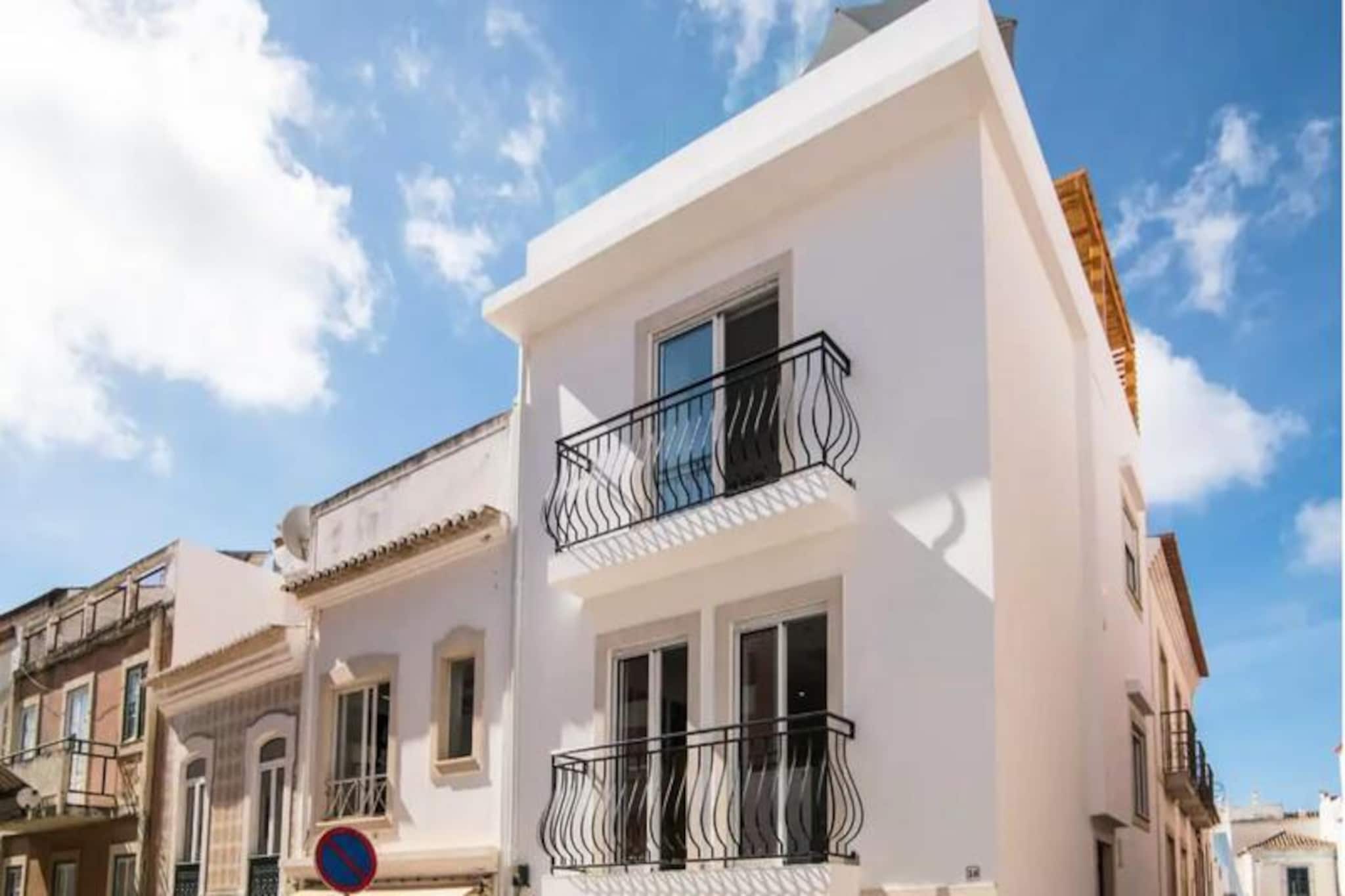 In the heart of Lagos' enchanting Old Town, this beautifully renovated 2-bedroom townhouse invites you to immerse yourself in the vibrant charm of the Algarve. With its cobblestone streets, historic architecture, and lively atmosphere, Lagos offers a perfect blend of tradition and modernity, making it an ideal destination for food lovers, culture enthusiasts, and sunseekers alike. From the moment you step inside, this home promises a unique and memorable stay. 
 
 Spread across four thoughtfully designed floors, the townhouse combines comfort and style. The open-plan living and kitchen area on the first floor is equipped with modern appliances, perfect for preparing fresh seafood from the nearby fish market or produce from the weekly farmers' market. The ground floor features a cozy double bedroom with an en-suite bathroom and a convenient laundry area. On the third floor, you’ll find a dedicated office space for remote work and a second double bedroom with its own en-suite. The crown jewel of the property is the rooftop terrace, offering panoramic views of Meia Praia beach and the Old Town. Here, you can bask in the sun, enjoy a barbecue, or simply unwind with a glass of wine as the sun sets over the Algarve. 
 
 Step outside, and you’re just a short stroll from Lagos Marina, bustling with restaurants, bars, and shops. Explore the historic center, indulge in the local cuisine, or embark on a boat trip to discover the dramatic cliffs and hidden caves that define this coastline. Whether you’re kayaking along the crystal-clear waters or savoring a leisurely meal at a seaside café, Lagos offers endless opportunities for adventure and relaxation. 
 
 This townhouse is your perfect base for exploring the Algarve, offering privacy, modern amenities, and an unbeatable location. Please note, due to its multi-level design, the property is not suitable for children or those with mobility challenges. Let this charming retreat be your gateway to the beauty and culture of southern Portugal.