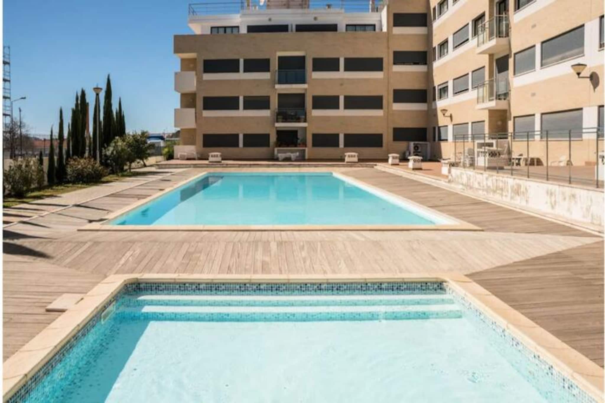 Awaken your senses in the heart of Tavira, where this modern two-bedroom apartment offers a serene retreat just moments from the town’s historic charm. Bathed in sunlight and thoughtfully designed, this property is perfect for those seeking comfort and convenience in the Algarve. Whether you’re strolling along the cobbled streets of Tavira’s old town or relaxing by the shared pool, this apartment provides the ideal base for your adventures. 
 
 Step inside to discover a bright and airy living space, complete with hardwood floors and tasteful decor. The fully equipped kitchen opens onto a private terrace, perfect for savoring your morning coffee or an evening drink. The living room invites you to unwind with a large television, free Wi-Fi, and a cozy dining area to enjoy meals with loved ones. The two bedrooms are designed for restful nights, featuring a double bed in one and two singles in the other, which can be combined to suit your needs. Air conditioning throughout ensures your comfort year-round. 
 
 Situated in a secure gated community, the property boasts a shared swimming pool and lush gardens for your enjoyment. Just steps away, the Gran Plaza shopping center offers a variety of shops, a supermarket, a cinema, and dining options. A short 10-15 minute walk leads you to Tavira’s historic center, where you can explore its charming streets, riverside cafes, and renowned restaurants serving fresh seafood and local delicacies. 
 
 For beach lovers, the stunning Praia de Tavira is easily accessible via a short ferry ride, offering pristine sands and crystal-clear waters. Golf enthusiasts will appreciate the proximity to world-class courses like Monte Rei, while nature lovers can explore the Ria Formosa Natural Park, a haven of unspoiled beauty. Whether you’re here to relax, explore, or indulge in the Algarve’s vibrant culture, this apartment promises an unforgettable stay.