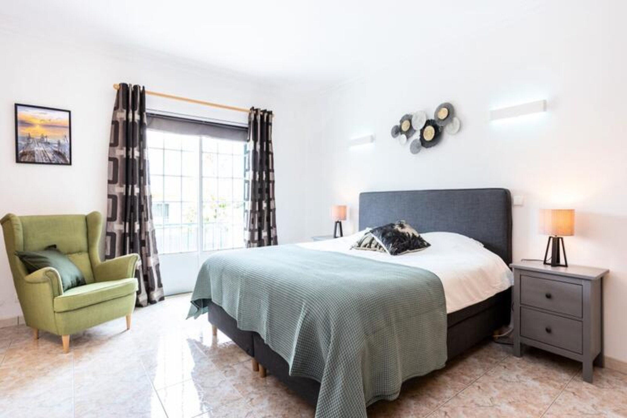 In the heart of the Algarve, where the golden coastline meets lush orchards, Casa Primavera offers a serene retreat just minutes from Albufeira’s vibrant center. This charming townhouse is part of an exclusive condominium of six homes, blending tranquility with proximity to the region’s lively attractions. Whether you’re seeking a family getaway or a trip with friends, this property promises comfort and unforgettable memories. 
 
 Step inside and discover a thoughtfully renovated space featuring three spacious bedrooms, each with a king-size bed and private bathroom. The fully equipped kitchen invites you to prepare delicious meals, while the cozy living room opens onto a private garden complete with a barbecue area. Adjacent to the garden, a large fenced communal pool awaits, perfect for cooling off after a day exploring the Algarve’s stunning beaches and landscapes. Modern amenities like Wi-Fi, air conditioning, and a wood-burning stove ensure your stay is as comfortable as it is memorable.
 
 Casa Primavera’s location is ideal for exploring Albufeira and beyond. Just a 7-minute drive away, the historic town center offers a mix of charming bars, restaurants, and vibrant nightlife. For a more peaceful experience, the surrounding area boasts pristine beaches, hidden coves, and picturesque trails. Venture further to discover the Algarve’s treasures, from the dramatic cliffs of Lagos to the serene beaches of Portimão.
 
 Whether you’re relaxing by the pool, enjoying a barbecue in your private garden, or exploring the Algarve’s breathtaking coastline, Casa Primavera is your perfect home away from home. Book your stay today and create lasting memories in this idyllic Portuguese retreat.