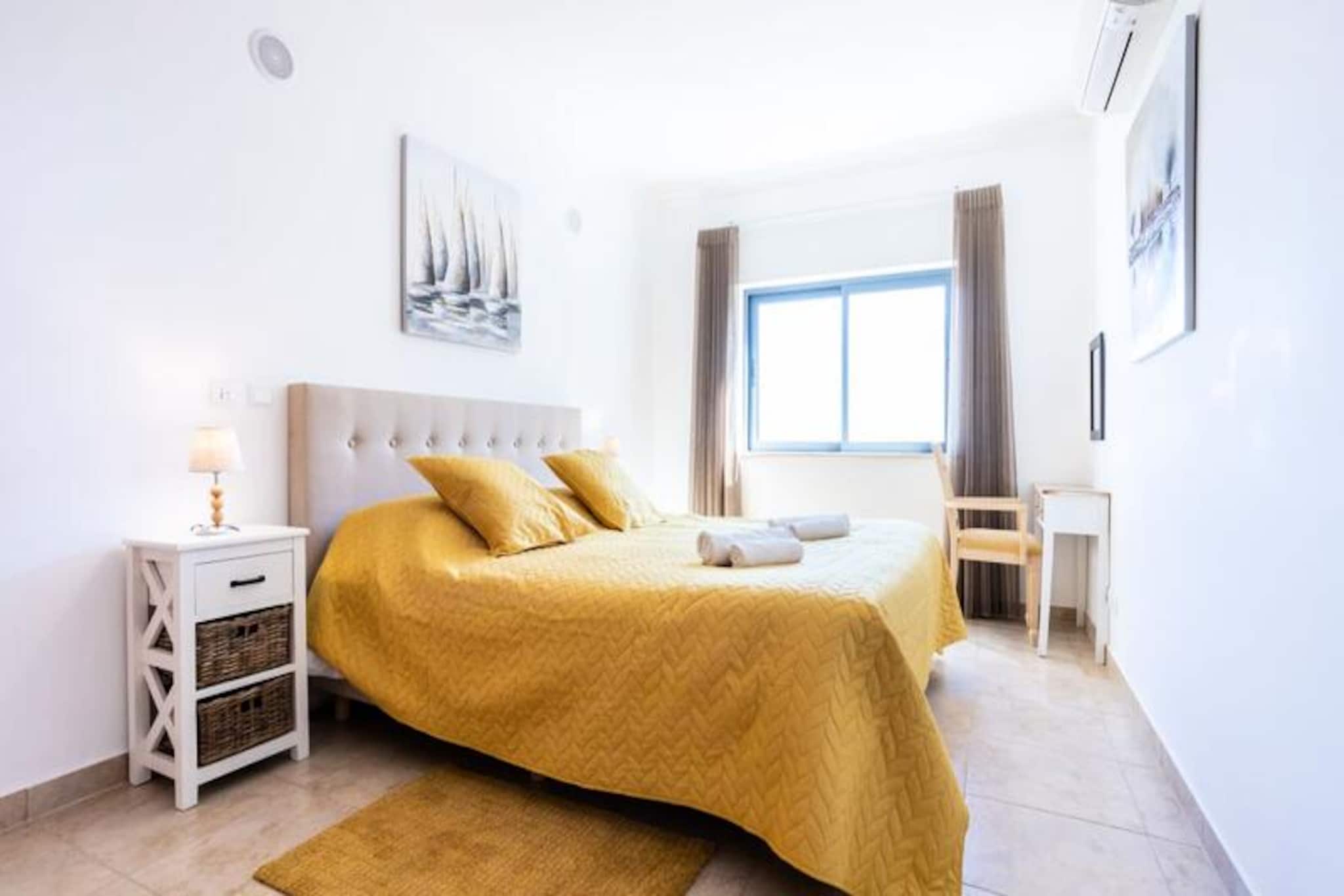 In the heart of the Algarve, where golden beaches meet historic charm, this delightful two-bedroom apartment offers the perfect retreat for your next holiday in Lagos. With its prime location just outside the bustling city center, you’ll enjoy the tranquility of a residential area while being steps away from vibrant restaurants, lively markets, and the stunning marina. Whether you're seeking relaxation or adventure, this apartment is your gateway to the best of Lagos. 
 
 Step inside to discover a spacious and thoughtfully designed interior, all on one level. The apartment features two comfortable bedrooms, one with a double bed and the other with two single beds, making it ideal for families or small groups. A fully equipped kitchen invites you to prepare delicious meals, while the large living room, complete with a sofa bed, provides a cozy space to unwind. The balcony offers beautiful views, perfect for enjoying your morning coffee or an evening glass of wine. With two bathrooms—one with a bathtub and the other with a shower—you’ll have all the convenience you need. Guests also have access to shared indoor and outdoor pools, a gym, and modern amenities like Wi-Fi and TV. 
 
 Located within walking distance of three large supermarkets, the beach, and the bus station, this apartment is perfectly positioned for exploring Lagos. Stroll through the historic center, where cobblestone streets lead to charming shops, bars, and restaurants. Don’t miss the breathtaking cliffs and hidden grottoes—best experienced on a boat, kayak, or paddleboard tour. For those seeking to venture further, Faro Airport is just an hour away by car, and Lagos’ train and bus stations connect you to other Portuguese gems. 
 
 Whether you’re here to soak up the sun, explore the rich history, or indulge in the local cuisine, this apartment offers the perfect blend of comfort, convenience, and Algarve charm. Book your stay today and create unforgettable memories in Lagos!