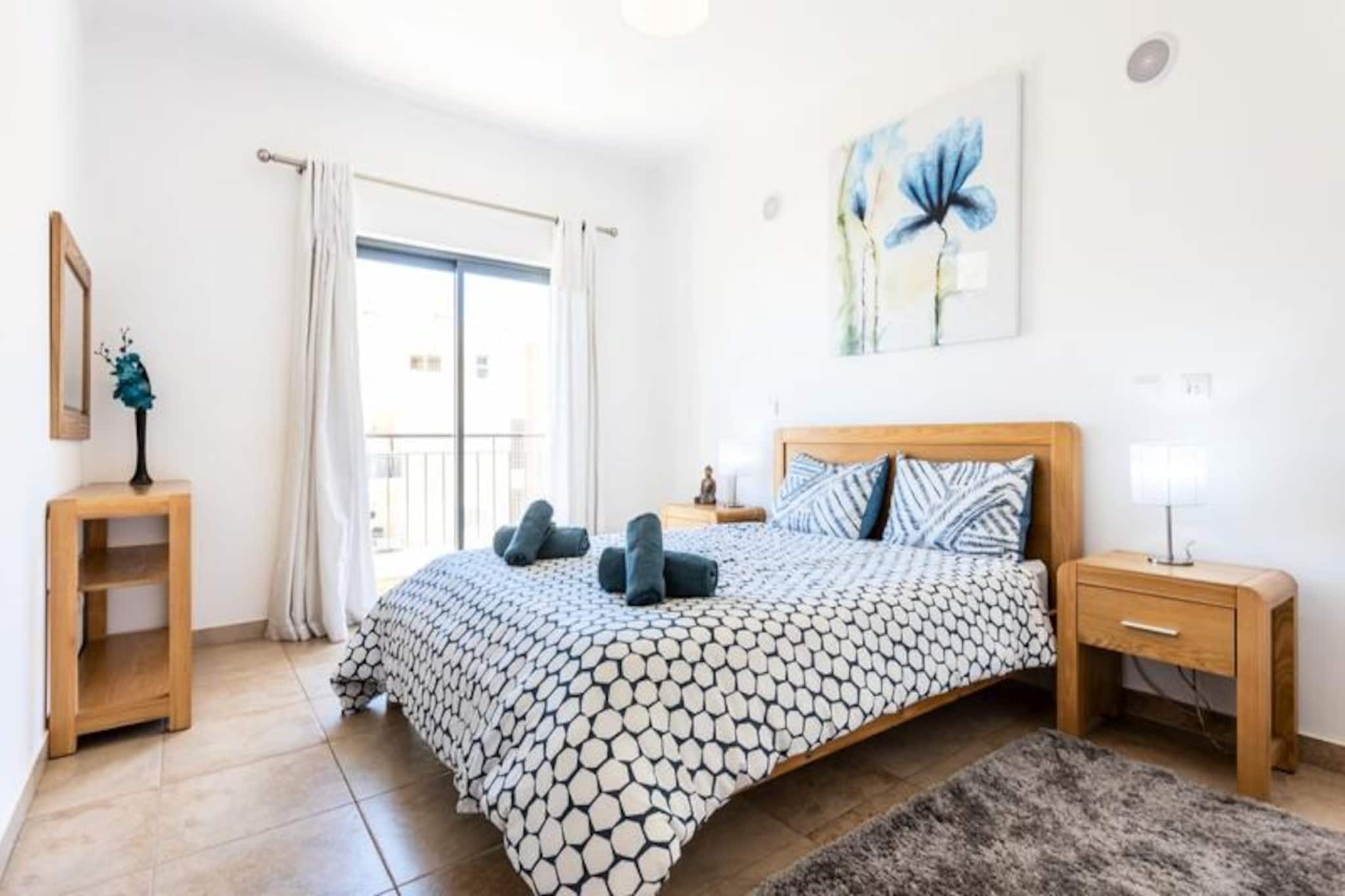 Overlooking the picturesque marina of Lagos, this stylish two-bedroom apartment offers the perfect blend of modern comfort and Algarve charm. Located on the edge of Lagos city center, it provides a serene retreat while keeping you close to the vibrant life of this historic coastal town. Imagine waking up to harbor views, enjoying your morning coffee on the balcony, and planning a day filled with sun, sea, and exploration. Whether you're here for a romantic getaway or a family holiday, this apartment sets the stage for unforgettable memories. 
 
 Inside, you'll find a thoughtfully designed space with a fully equipped kitchen, a spacious living room that opens onto the balcony, and two cozy bedrooms—one with a double bed and the other with two single beds. The apartment also features two modern bathrooms, one with a bathtub and the other with a shower, ensuring convenience for all guests. Additional amenities include Wi-Fi, a washing machine, and access to the building's shared indoor and outdoor pools, as well as a gym. With linens and towels provided, all you need to do is relax and enjoy. 
 
 Step outside, and you'll find yourself just a short walk from Lagos' lively historic center, where cobblestone streets lead to charming shops, bustling markets, and a variety of bars and restaurants. The golden sands of the beach and the marina are only five minutes away, making it easy to enjoy the Algarve's famous coastline. For those seeking adventure, we highly recommend a boat or kayak trip to explore the dramatic cliffs and hidden caves that define this stunning region. 
 
 Whether you're soaking up the sun by the pool, exploring the vibrant streets of Lagos, or venturing out to discover the Algarve's natural beauty, this apartment offers the ideal base for your holiday. With Faro Airport just an hour away and excellent transport links, your dream getaway is closer than you think.