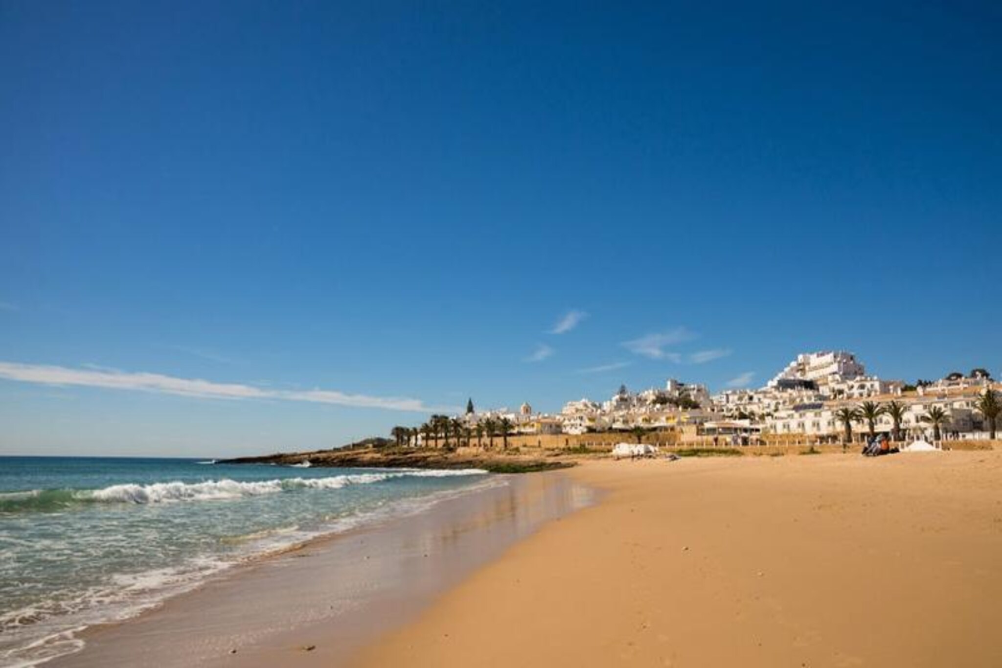 Wake up to the soothing sound of waves and the scent of the ocean breeze in this delightful 3-bedroom apartment, perfectly situated in the heart of Luz. With its prime location just steps from the beach and the charming village center, this property offers a serene retreat for families or friends seeking a memorable holiday along Portugal’s stunning Algarve coast. The south-facing terrace invites you to bask in the sun while enjoying breathtaking sea views, setting the tone for a truly relaxing getaway.
Inside, the apartment boasts a spacious and bright living area, a fully renovated kitchen equipped with modern appliances, and three comfortable bedrooms, including one with an en suite bathroom. Thoughtfully designed for your comfort, the property also features Wi-Fi, television, and private parking right in front of the apartment. The lush landscaped gardens surrounding the complex add to the tranquil ambiance, making it an ideal escape from the hustle and bustle of everyday life.
Beyond the apartment, Luz offers a wealth of attractions and activities. Stroll to the nearby beach for a day of sunbathing, surfing, or snorkeling, or explore the picturesque cliffs and coastal trails that define the Algarve’s natural beauty. The village itself is brimming with shops, restaurants, and bars, ensuring you have everything you need within walking distance. For a change of pace, the vibrant town of Lagos is just a short drive away, offering a historic center, lively marina, and opportunities for boat trips to discover the dramatic cliffs and hidden coves of the coastline.
Whether you’re seeking adventure, relaxation, or a mix of both, this apartment in Luz provides the perfect base for an unforgettable holiday. With its unbeatable location, modern amenities, and warm, inviting atmosphere, it’s a place where cherished memories are made.