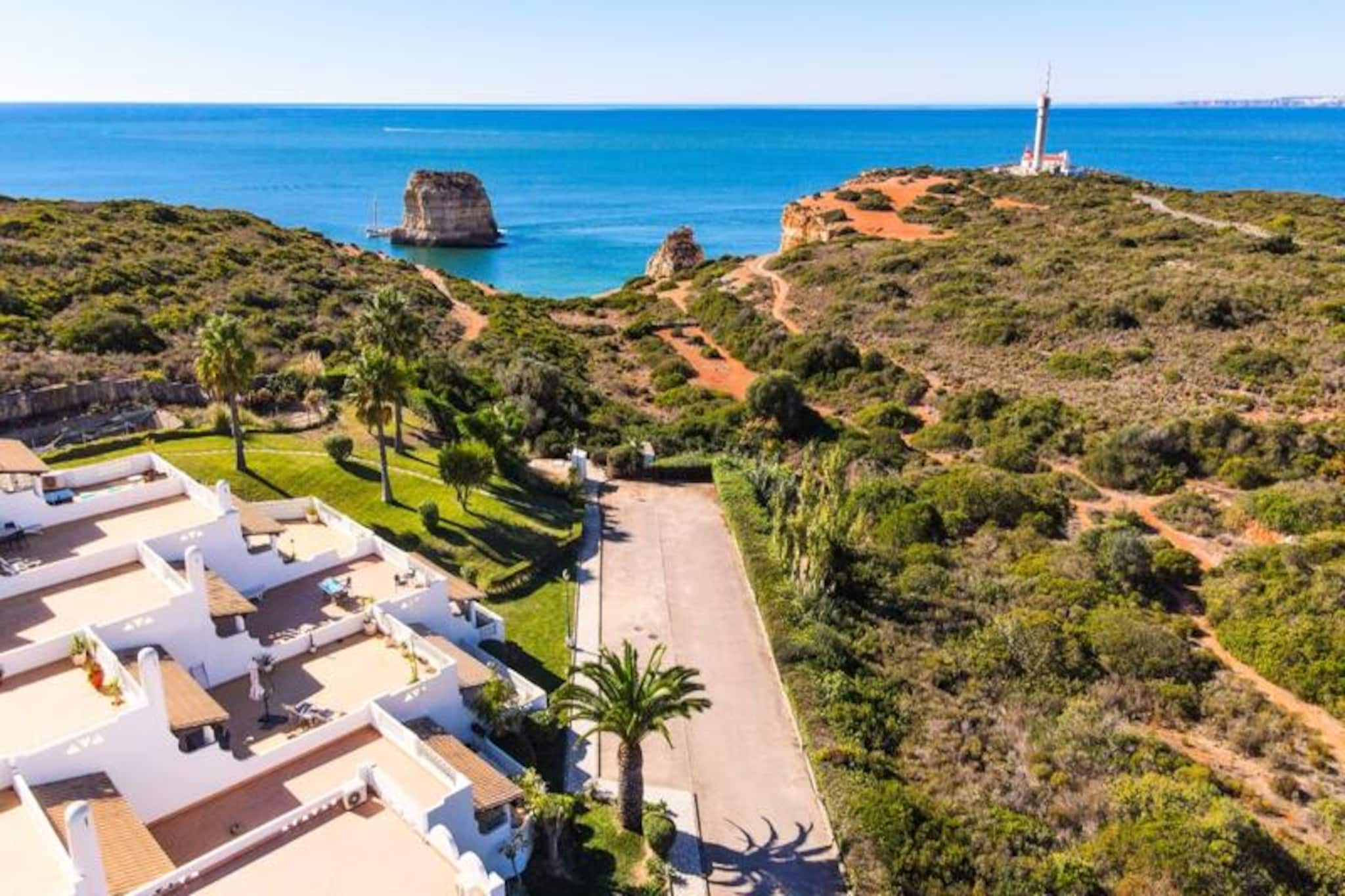 Imagine waking up to the soothing sounds of the ocean and stepping out onto your private terrace to savor the fresh coastal breeze. This beautifully designed terraced house, located in a serene and secure condominium near Ferragudo, offers the perfect blend of modern comfort and natural beauty. Surrounded by lush gardens and just a short walk from the golden sands of Praia dos Caneiros, this property is a true haven for relaxation and exploration. 
 
 Step inside and be greeted by a bright and inviting living space. The ground floor features a spacious living room that opens onto a fantastic terrace with a barbecue, perfect for al fresco dining while enjoying views of the gardens and nearby nature reserve. The fully equipped modern kitchen, complete with brand-new appliances, ensures a seamless cooking experience. Upstairs, two elegant bedrooms with built-in wardrobes each boast their own private terraces, offering unobstructed and tranquil views. The house also includes two stylish bathrooms, one with a walk-in shower, and a separate toilet for added convenience. 
 
 Beyond the property, the location is unbeatable. A short five-minute walk takes you to the stunning Praia dos Caneiros, where you can bask in the sun or explore the dramatic coastline. The charming village of Ferragudo, with its quaint streets and delightful restaurants, is just a two-minute drive away. For those seeking more adventure, the bustling city of Portimão is within easy reach, offering shopping, dining, and cultural experiences. 
 
 Whether you're looking for a peaceful retreat or a base to explore the Algarve's treasures, this house is the ideal choice. With its tasteful decor, modern amenities, and prime location, it promises an unforgettable holiday experience. Book your stay today and create lasting memories in this coastal paradise.