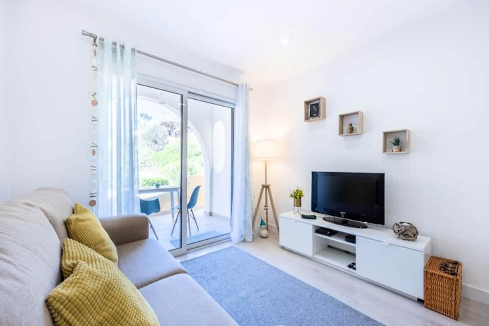 Perched above the golden sands of Praia de Centeanes, this stunning apartment offers an unparalleled seaside escape. Imagine waking up to the soothing sound of waves and stepping out onto your private terrace to take in breathtaking ocean views. Just a minute’s walk from the beach, this is a haven for those seeking relaxation and the charm of coastal living in the heart of the Algarve. The vibrant village of Carvoeiro, with its traditional Portuguese flair, is just around the corner, offering a delightful mix of restaurants, shops, and local culture. 
 
 The apartment is thoughtfully designed to ensure your comfort. The spacious living room, bathed in natural light from large windows, is perfect for unwinding after a day of exploring. A fully equipped kitchen invites you to prepare meals with fresh local ingredients, while two modern bathrooms and cozy bedrooms provide all the convenience you need. The highlight is undoubtedly the terrace, where you can enjoy your morning coffee or a glass of wine as the sun sets over the Atlantic. With Wi-Fi, cable TV, and complimentary linens and towels, every detail has been considered to make your stay seamless.
 
 Beyond the property, the Algarve awaits. From the dramatic cliffs and hidden coves accessible only by boat to the renowned golf courses and water sports, there’s something for everyone. The nearby Serra de Monchique offers unforgettable mountain biking trails, while the local seafood restaurants serve up the freshest catches of the day. Whether you’re here to relax or explore, this apartment is the perfect base for your Algarve adventure.
 
 With Faro Airport just an hour away and parking available on-site, your journey to this coastal paradise is as effortless as your stay will be memorable. Don’t miss the chance to experience the magic of Praia de Centeanes and the Algarve’s timeless beauty.