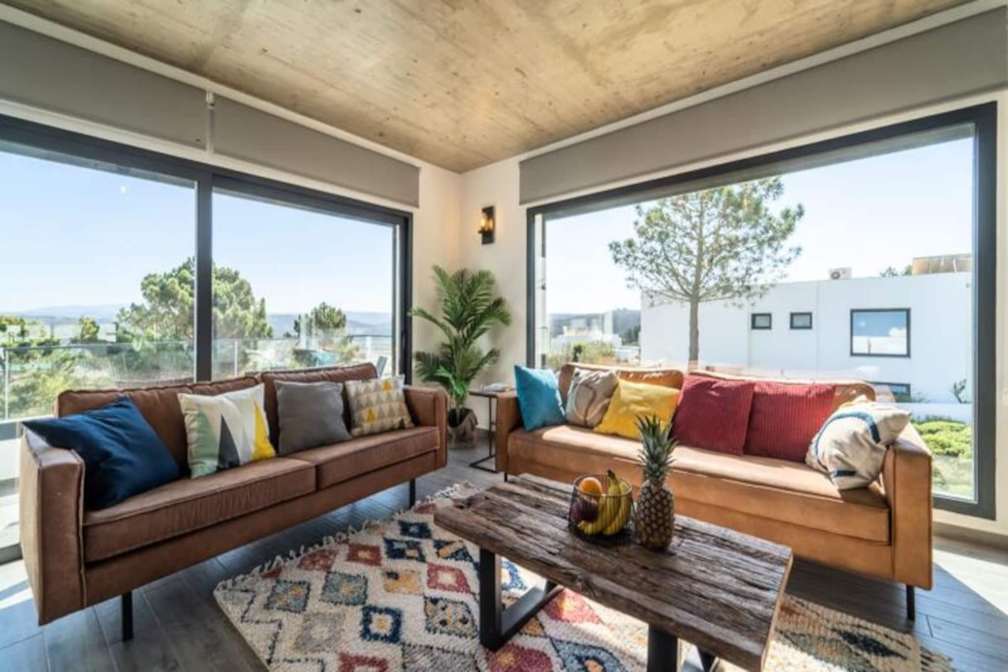 Overlooking the serene Amoreira River and nestled within the breathtaking Vicentine Coast Natural Park, this stunning villa in Espartal offers a tranquil escape just moments from the golden sands of Monte Clérigo and Amoreira beaches. Here, the rhythm of the Atlantic waves and the beauty of unspoiled nature create an idyllic setting for your next getaway. Whether you're seeking adventure or relaxation, this villa is a gateway to the best of Aljezur's coastal charm.
The villa boasts three spacious bedrooms, each with its own en-suite bathroom, ensuring privacy and comfort for up to six guests. The modern open-plan design seamlessly connects indoor and outdoor living spaces, with large panoramic windows that flood the interiors with natural light and offer stunning views of the surrounding landscape. Enjoy the private pool, sauna, and multiple terraces, perfect for soaking up the Algarve sun. The fully equipped kitchen, complete with high-end Samsung appliances and thoughtful touches like a Nespresso machine and local artwork, ensures a luxurious and homely stay. For digital nomads, high-speed Wi-Fi is available throughout the property.
Step outside to discover a private oasis with a barbecue area, outdoor shower, surfboard rack, and wetsuit drying space, catering to surfers and outdoor enthusiasts. The villa's location in Espartal provides easy access to the area's world-class surf spots, scenic coastal trails, and charming local restaurants. Monte Clérigo Beach is just a short walk away, and the picturesque Amoreira Beach can be reached at low tide for a unique adventure.
By choosing this villa, you're not only treating yourself to a luxurious stay but also contributing to a greater cause. All profits from your booking are donated to the Luena Foundation, supporting children's rights worldwide. Create unforgettable memories in this peaceful retreat, where the harmony of nature and comfort awaits.