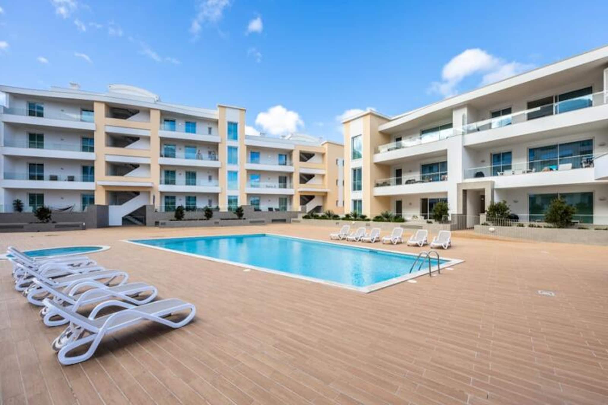 Immerse yourself in the vibrant charm of Lagos with this luxurious three-bedroom apartment, perfectly situated between the marina and the historic old town. This modern retreat offers a serene escape while keeping you close to the heart of the Algarve's most captivating attractions. From the moment you arrive, you'll be greeted by a blend of contemporary elegance and coastal tranquility, making it the ideal base for your Portuguese getaway. 
 
 Step inside to discover a spacious open-plan living area, bathed in natural light, complete with a fully equipped kitchen and a large terrace perfect for unwinding after a day of exploration. Each bedroom is designed with your comfort in mind, featuring air conditioning, electric blinds, and plush bedding. With three modern bathrooms and a private balcony accessible from one of the bedrooms, this apartment effortlessly combines style and functionality. Guests also have access to a communal swimming pool, providing a refreshing oasis just steps from your door. 
 
 The location is unparalleled, with Lagos' iconic beaches—Praia Dona Ana, Praia de Porto de Mos, and Praia do Camilo—just a short stroll away. Explore the picturesque Ponte de Piedade, a 30-minute walk or a quick drive, and marvel at one of Portugal's most photographed coastal views. The historic center, with its cobbled streets, vibrant markets, and charming cafés, is only 15 minutes on foot. For golf enthusiasts, the Boavista Golf Course is a mere 6-minute drive, while nearby supermarkets and shops ensure convenience throughout your stay. 
 
 Whether you're seeking adventure, relaxation, or a mix of both, this apartment offers the perfect blend of luxury and location. Book your stay today and create unforgettable memories in the enchanting town of Lagos.