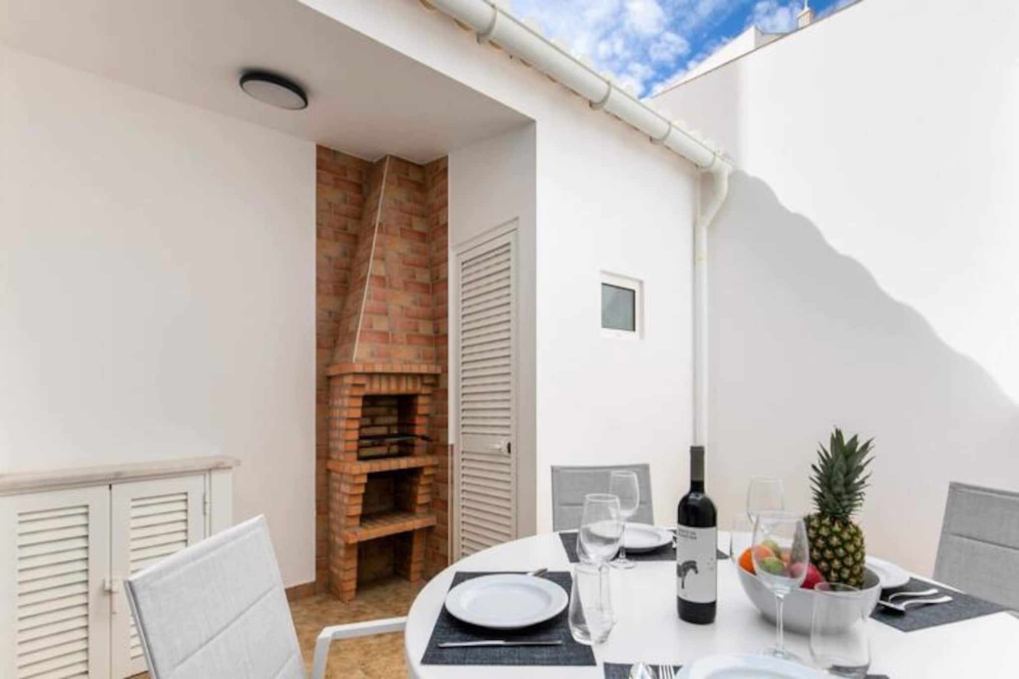In the heart of Lagos, where cobblestone streets weave through a vibrant old town, this spacious 3-bedroom townhouse offers a serene retreat amidst the lively charm of the Algarve. Just steps from bustling shops, bars, and restaurants, yet tucked away on a quiet residential street, this home is a perfect blend of tranquility and convenience. From the moment you step inside, the bright and airy interiors invite you to unwind and embrace the relaxed coastal lifestyle. 

The property boasts a thoughtful layout designed for comfort and ease. The ground floor features a cozy living room with a plush sofa and television, a queen-sized bedroom, and a separate bathroom. The fully equipped kitchen, complete with a dining table, opens onto a charming patio with an outdoor dining area and barbecue—ideal for morning coffees or al fresco dinners. Upstairs, two twin bedrooms and a second bathroom offer ample space for families or groups, while the rooftop terrace provides a private sanctuary to soak up the sun or enjoy evening breezes. 

Lagos’ stunning beaches are within walking distance, including the golden sands of Batata Beach and the expansive Meia Praia. The iconic cliffs of Praia Dona Ana and Ponte de Piedade are just a short drive or leisurely stroll away. For those seeking adventure, the area offers kayaking, stand-up paddleboarding, and boat tours to explore the dramatic coastline. The town’s historic center, with its marina, markets, and delectable cuisine, ensures there’s something for everyone. 

Whether you’re here to relax, explore, or indulge in the Algarve’s natural beauty, this townhouse provides the perfect base for an unforgettable holiday. Let the charm of Lagos and the comfort of this home create memories you’ll cherish forever.