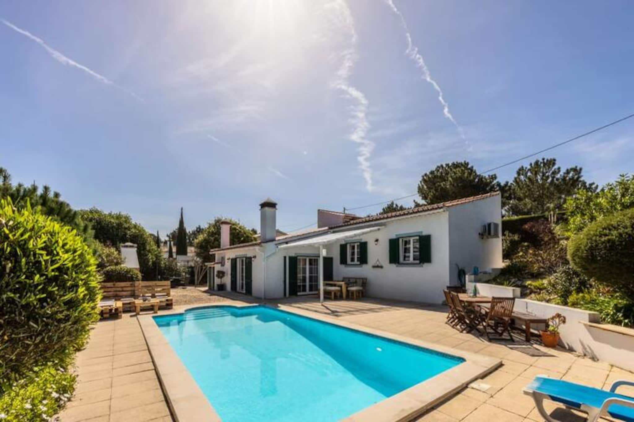 In the serene embrace of Vale da Telha, this elegant villa offers a tranquil retreat amidst the natural beauty of Portugal’s Costa Vicentina Nature Reserve. Surrounded by lush greenery and just moments from golden beaches, it’s a haven for families, surfers, and nature enthusiasts alike. The villa’s refined design and peaceful ambiance create an inviting space to unwind and reconnect with loved ones. 
 
 Step inside to discover a bright and airy home with three beautifully appointed bedrooms and two modern bathrooms. The open-plan kitchen and dining area, complete with a wood-burning stove, flows seamlessly onto a sun-drenched terrace overlooking the private pool. The living room, bathed in natural light from large windows and doors, opens onto both the front and back gardens, creating a harmonious blend of indoor and outdoor living. Modern amenities such as air conditioning, Wi-Fi, and a fully equipped kitchen ensure your stay is as comfortable as it is memorable.
 
 Outside, the villa truly shines. The private pool area, sheltered and secluded, invites you to relax under the sun or enjoy al fresco meals prepared in the outdoor BBQ kitchen. The large fenced garden provides ample space for children to play or for quiet moments of reflection. With private parking and thoughtful touches throughout, this villa is designed for effortless holiday living.
 
 Located just a short drive from the stunning beaches of Monte Clérigo and Arrifana, as well as local bars, restaurants, and markets, the villa enjoys a prime position in the sought-after Vale da Telha. Explore the historic town of Aljezur, hike the breathtaking trails of the Costa Vicentina, or simply soak in the beauty of this unspoiled region. Whether you’re seeking adventure or relaxation, this villa offers the perfect base for an unforgettable escape.