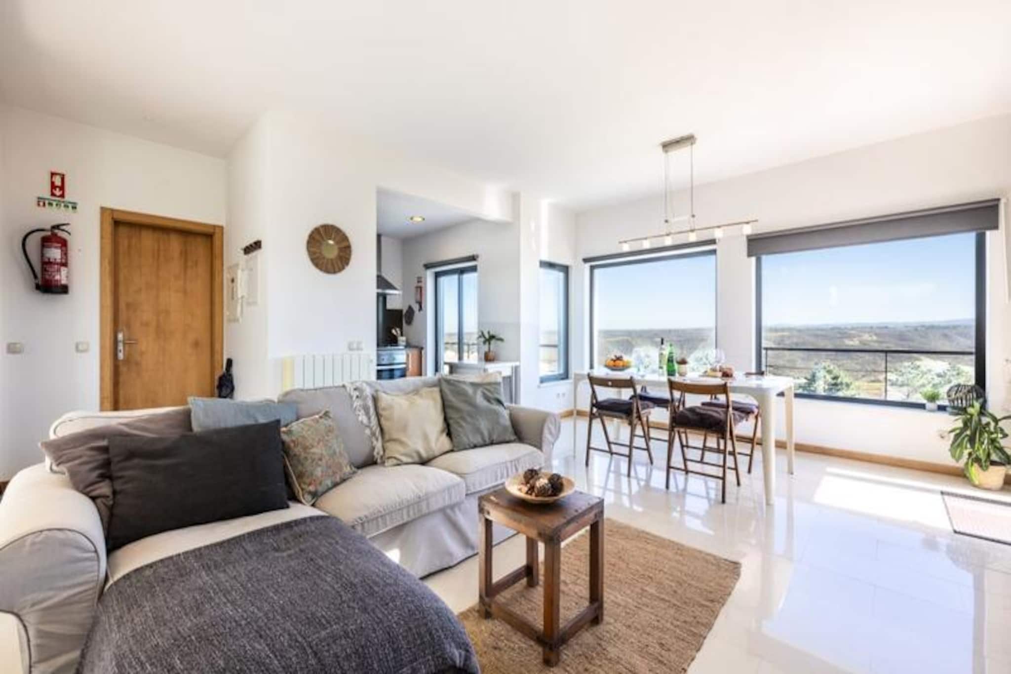 Wake up to the serene beauty of the Amoreira River and the rolling hills of the Costa Vicentina Natural Park, where nature's tranquility sets the tone for your day. This inviting three-bedroom villa in the peaceful Espartal neighborhood offers an idyllic retreat for families and nature lovers alike, just a short walk from the golden sands of Monte Clérigo and Amoreira beaches. The surrounding area is a haven for surfers, hikers, and those seeking a slower pace of life amidst breathtaking coastal landscapes. 
 
 Step inside to discover a bright and airy living space with a cozy fireplace, perfect for unwinding after a day of adventure. The open-plan kitchen and dining area are designed for convivial meals, with large windows framing views of the lush surroundings. Downstairs, three spacious bedrooms provide restful retreats, each with direct access to the garden patio. The master bedroom features an en-suite bathroom, while the other two bedrooms, each with three single beds, share a modern bathroom with a shower. 
 
 Outside, the villa’s garden and balcony with a barbecue invite you to savor al fresco dining under the Algarve sun. Nearby, the charming town of Aljezur offers a taste of local culture, from its historic castle to its vibrant markets brimming with regional delicacies like sweet potatoes and fresh seafood. The Rota Vicentina trails beckon for scenic walks, while the sound of crashing waves provides the perfect soundtrack to your stay. 
 
 Whether you’re here to surf world-class waves, explore the unspoiled coastline, or simply relax in a peaceful setting, this villa is your gateway to the best of the Algarve. With its blend of comfort, privacy, and proximity to nature, it promises an unforgettable escape.