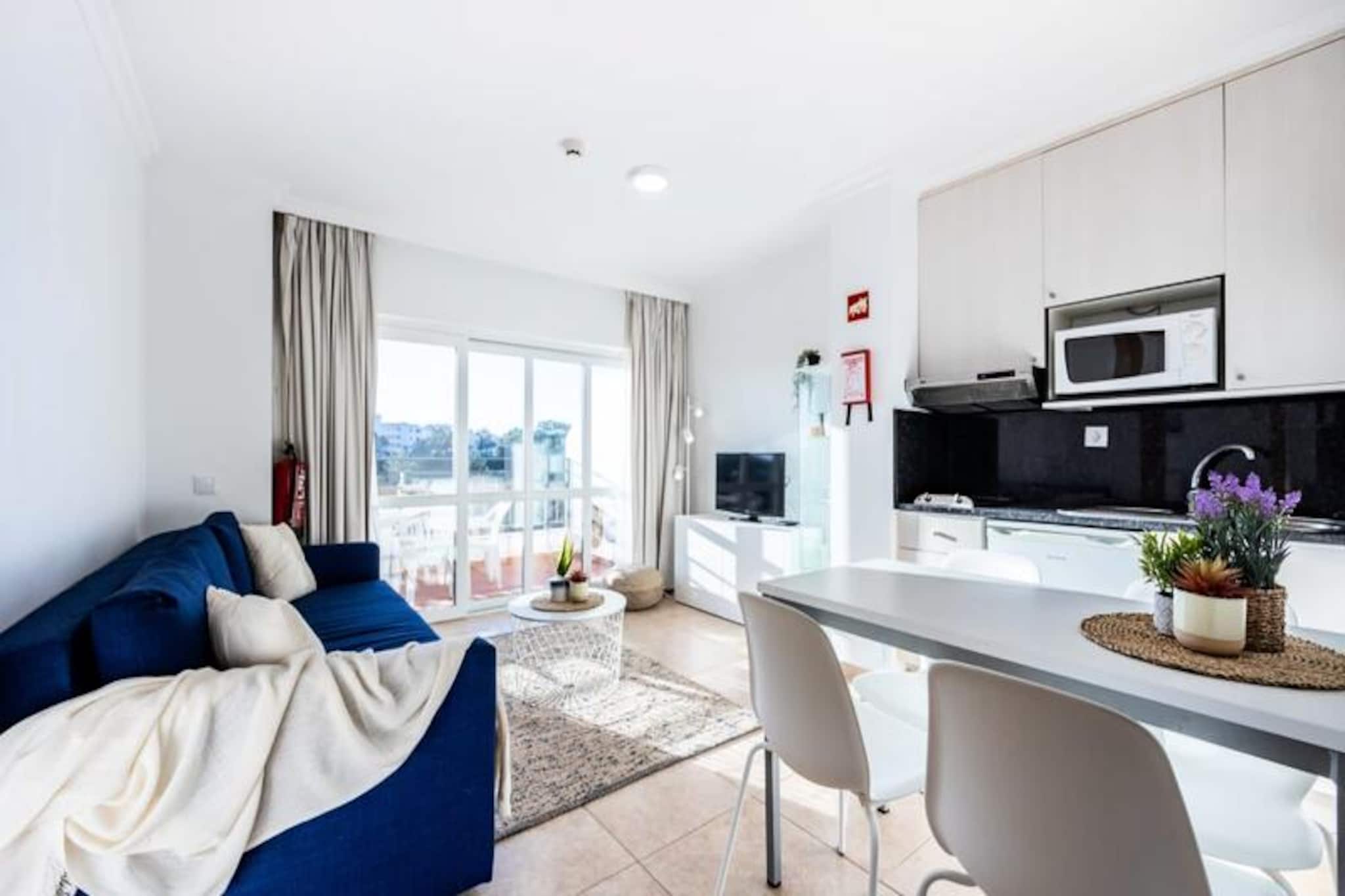 Wake up to the sound of waves and the golden glow of the Algarve sun in this bright, modern one-bedroom apartment in Praia do Vau, Portimão. Perfectly situated just a short stroll from the beach, this stylish retreat offers an ideal blend of relaxation and convenience for families or couples seeking a memorable seaside escape. Whether you're sipping your morning coffee on the private balcony with ocean views or enjoying the vibrant local dining scene, this apartment is your gateway to the best of the Algarve. 
 
 Inside, the apartment is thoughtfully designed for comfort and style. The airy living and dining area is bathed in natural light, providing a welcoming space to unwind after a day at the beach. The fully equipped kitchen invites you to prepare your favorite meals, while the cozy bedroom with a double bed and a sofa bed in the living room ensures restful nights for up to four guests. Modern amenities such as Wi-Fi, a flat-screen TV, and air conditioning make your stay as comfortable as possible.
 
 Step outside, and you'll find yourself surrounded by the charm of Praia do Vau. Explore the golden sands and crystal-clear waters just minutes away, or take a leisurely walk to nearby restaurants, shops, and cafes. For those looking to venture further, Portimão's bustling marina, the lively Praia da Rocha, and the stunning cliffs of Alvor are all within easy reach. Families will love the proximity to Zoomarine and other nearby attractions, while adventurers can explore the Algarve's scenic coastline and hidden coves.
 
 With free parking, excellent transport links, and a dedicated management team ready to assist, this apartment offers everything you need for a stress-free holiday. Book your stay today and experience the magic of the Algarve from the comfort of this modern seaside retreat.