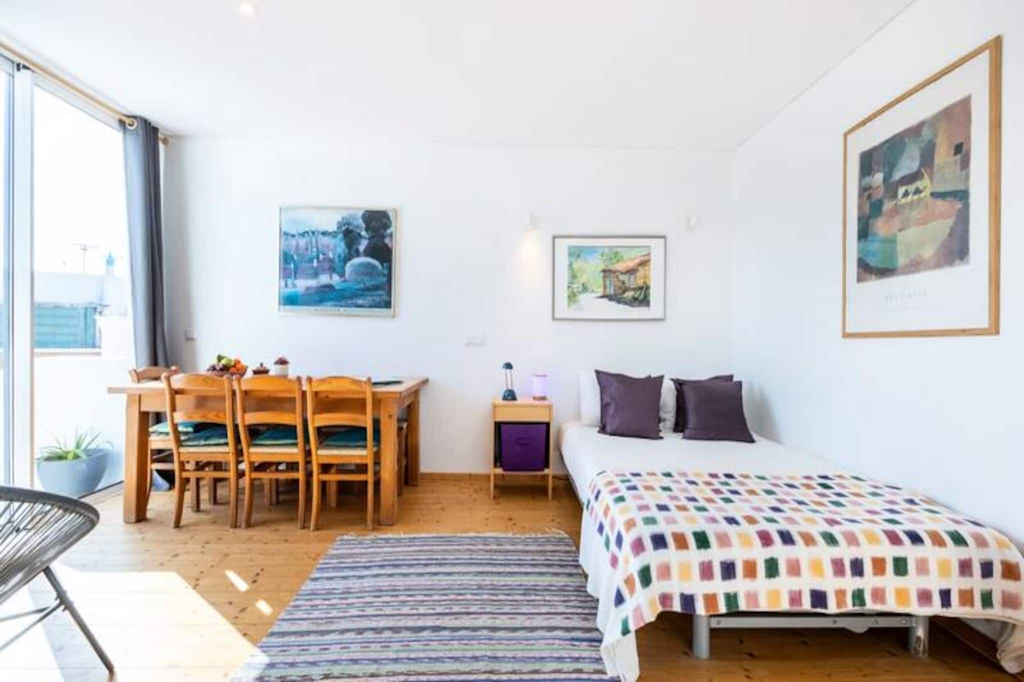 In the vibrant heart of Olhão, a picturesque fishing town near Faro, this charming studio offers a delightful retreat for couples or solo travelers seeking an authentic Algarve experience. The Culatra studio, named after one of the region's idyllic islands, is located on the second floor of a recently renovated house, blending modern comfort with traditional charm. With its private entrance and cozy ambiance, it’s the perfect base to explore the beauty of southern Portugal.  
                      Inside, the studio is thoughtfully designed with a well-equipped kitchenette featuring a 2-burner induction hob, microwave, refrigerator, and dishwasher. The living space includes a comfortable sofa that converts into a double bed, air conditioning, and Wi-Fi to ensure a relaxing stay. Large windows provide excellent ventilation, while the private terrace invites you to unwind under the sun. Guests also have access to the shared rooftop terrace, offering panoramic views of Olhão’s historic rooftops and the sparkling waters beyond.  
                      Just steps away, the town center buzzes with life, boasting a rich blend of Portuguese culture, history, and gastronomy. Stroll to the local market, savor fresh seafood at waterfront restaurants, or hop on a ferry to the tranquil islands of Armona and Culatra. With shops, bars, and a supermarket within walking distance, everything you need is at your fingertips.  
                      Whether you’re exploring the Algarve’s pristine beaches, discovering hidden villages, or simply soaking in the laid-back coastal vibe, this studio offers a welcoming haven to return to at the end of each day. Experience Olhão’s charm and create unforgettable memories in this unique setting.