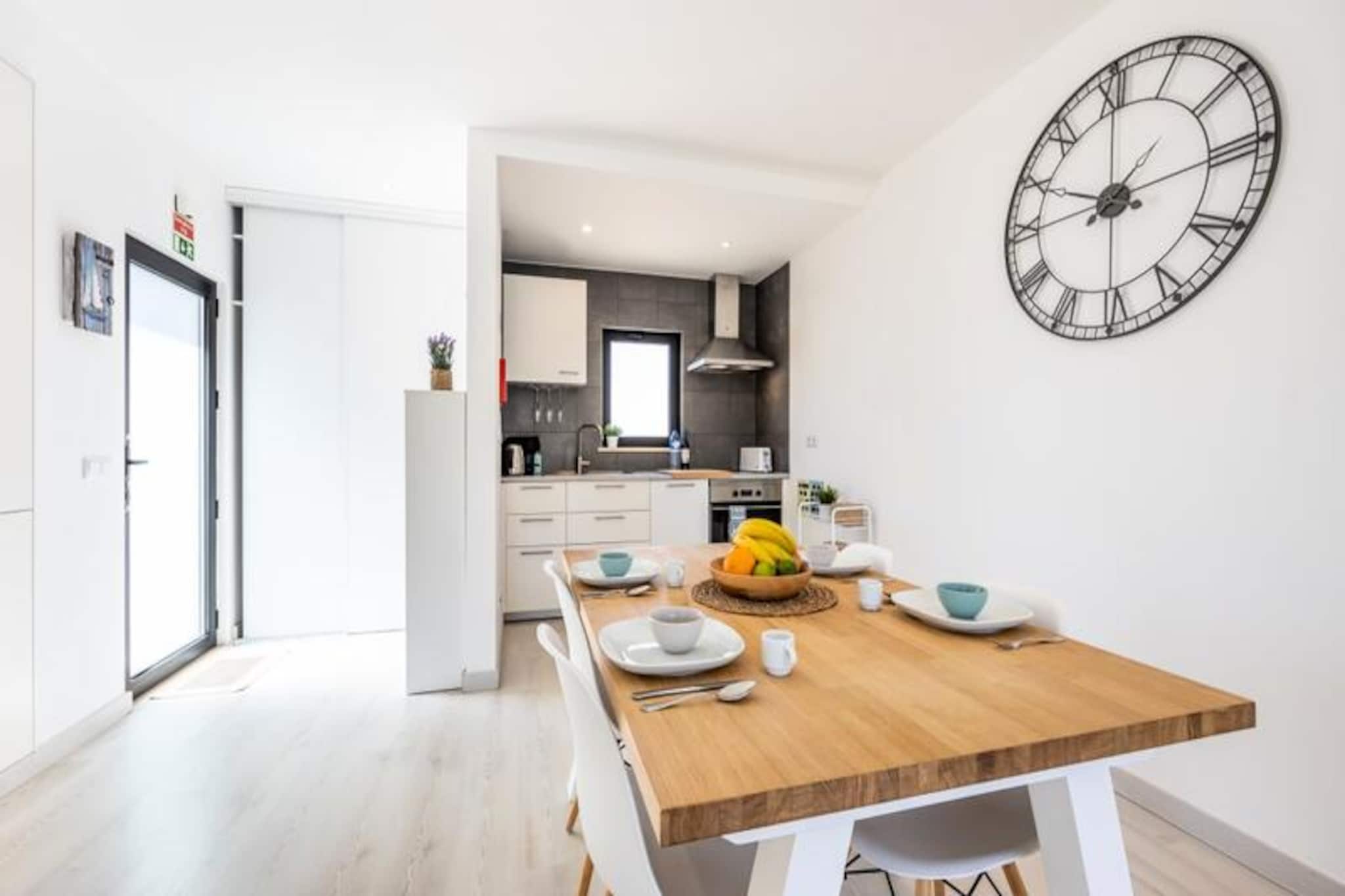 In the serene coastal town of Sagres, this charming holiday home offers a tranquil retreat for up to four guests. Perfectly situated at the town’s entrance, the property is just a short drive from the golden sands of Martinhal and Tonel beaches, making it an ideal base for surfers, beach lovers, and nature enthusiasts alike. The Algarve’s natural beauty surrounds you, offering a peaceful escape from the everyday. 

Step inside to discover a bright and modern living space, thoughtfully designed for comfort and relaxation. The living room features a large bay window that floods the space with natural light and provides a view of the private garden and pool. A cozy sofa, satellite TV, and dining area create the perfect setting for unwinding after a day of adventure. The open-plan kitchen is fully equipped with modern appliances, including a ceramic hob, oven, microwave, dishwasher, and fridge/freezer, ensuring you have everything needed to prepare delicious meals. 

Outside, the private garden invites you to soak up the Algarve sunshine. Take a refreshing dip in the swimming pool or relax on the southeast-facing terrace with a book or a glass of wine. The peaceful residential setting ensures a restful stay, while the proximity to local amenities and beaches adds convenience. Private parking is available, and a rental car is recommended for exploring the stunning coastline and nearby attractions. 

Whether you’re here to surf the waves, explore the dramatic cliffs of the Algarve, or simply unwind in the sun, this holiday home offers the perfect blend of comfort and location. With its modern amenities and serene atmosphere, it’s a haven for families or responsible adults seeking a memorable getaway in one of Portugal’s most picturesque regions.