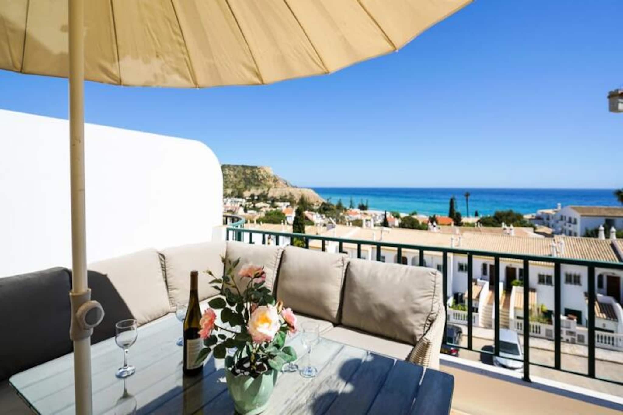 Imagine waking up to the soothing sound of waves and enjoying your morning coffee on a spacious balcony with uninterrupted views of the Atlantic Ocean. This bright and beautifully renovated 2-bedroom, 2-bathroom apartment in Luz offers the perfect blend of comfort and coastal charm, making it an ideal retreat for families or couples seeking a serene getaway. Located on the third floor of a hillside building, the apartment provides breathtaking panoramic views of the town and sea, creating a tranquil atmosphere that feels worlds away from the everyday hustle. 
 
 Inside, the apartment is thoughtfully designed with a mix of modern and classic furnishings, offering a warm and inviting space for up to six guests. The master bedroom features a comfortable double bed, while the second bedroom has two single beds. A sofa in the living room converts into a small double bed, perfect for children under 14. The fully equipped kitchen invites you to prepare delicious meals, while the airy living area is perfect for unwinding after a day of exploration. Linens, towels, Wi-Fi, and a television are all provided to ensure a hassle-free stay. 
 
 The location is unbeatable: just a 10-minute walk to the golden sands of Praia da Luz and its vibrant array of restaurants, bars, and shops. Guests also enjoy complimentary access to the pool facilities at the nearby Luz Bay Hotel, with additional amenities like tennis courts and a spa available for booking. Whether you spend your days lounging by the pool, exploring the dramatic Algarve coastline, or visiting the historic town of Lagos just 15 minutes away, this apartment serves as the perfect base for your adventures. 
 
 With its stunning views, comfortable amenities, and prime location, this Luz apartment promises an unforgettable holiday experience. Book your stay today and immerse yourself in the beauty of Portugal’s Algarve coast.