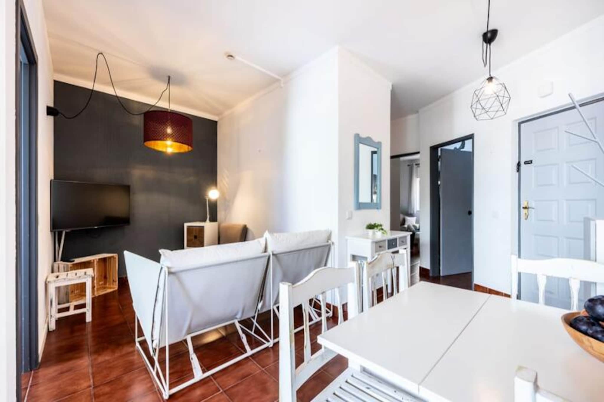 Imagine waking up to the soft sound of waves and the warm embrace of the Algarve sun in this beautifully renovated 2-bedroom apartment in Alvor. Nestled within a private condominium, this family-friendly retreat offers the perfect blend of comfort and convenience, making it an idyllic escape for your next holiday. With its modern design, abundant natural light, and air conditioning, the apartment ensures a relaxing and refreshing stay for all guests. The spacious terrace, overlooking the charming town of Alvor, is the ideal spot to enjoy a morning coffee or a family dinner under the stars. 
 
 Inside, the apartment boasts a fully equipped kitchen, perfect for preparing delicious meals with fresh local ingredients. The two bedrooms are designed for restful nights, while the open-plan living area invites you to unwind after a day of exploring. Guests also have access to a shared swimming pool, a kids' club, and an on-site restaurant with a bar, ensuring entertainment and relaxation for the whole family. During peak season, the condominium comes alive with evening activities, creating a vibrant community atmosphere. 
 
 Alvor itself is a gem of the Algarve, offering golden beaches, a picturesque fishing village charm, and a variety of outdoor activities. The stunning Tres Irmãos beach is just a short drive away, while the famous Praia da Rocha beach and the natural beauty of the Ria de Alvor estuary are also within easy reach. For families, nearby attractions like the Slide and Splash water park and Zoomarine promise unforgettable adventures. 
 
 Whether you're seeking relaxation, exploration, or family fun, this apartment in Alvor is your gateway to the best of the Algarve. Book your stay today and create cherished memories in this seaside paradise.