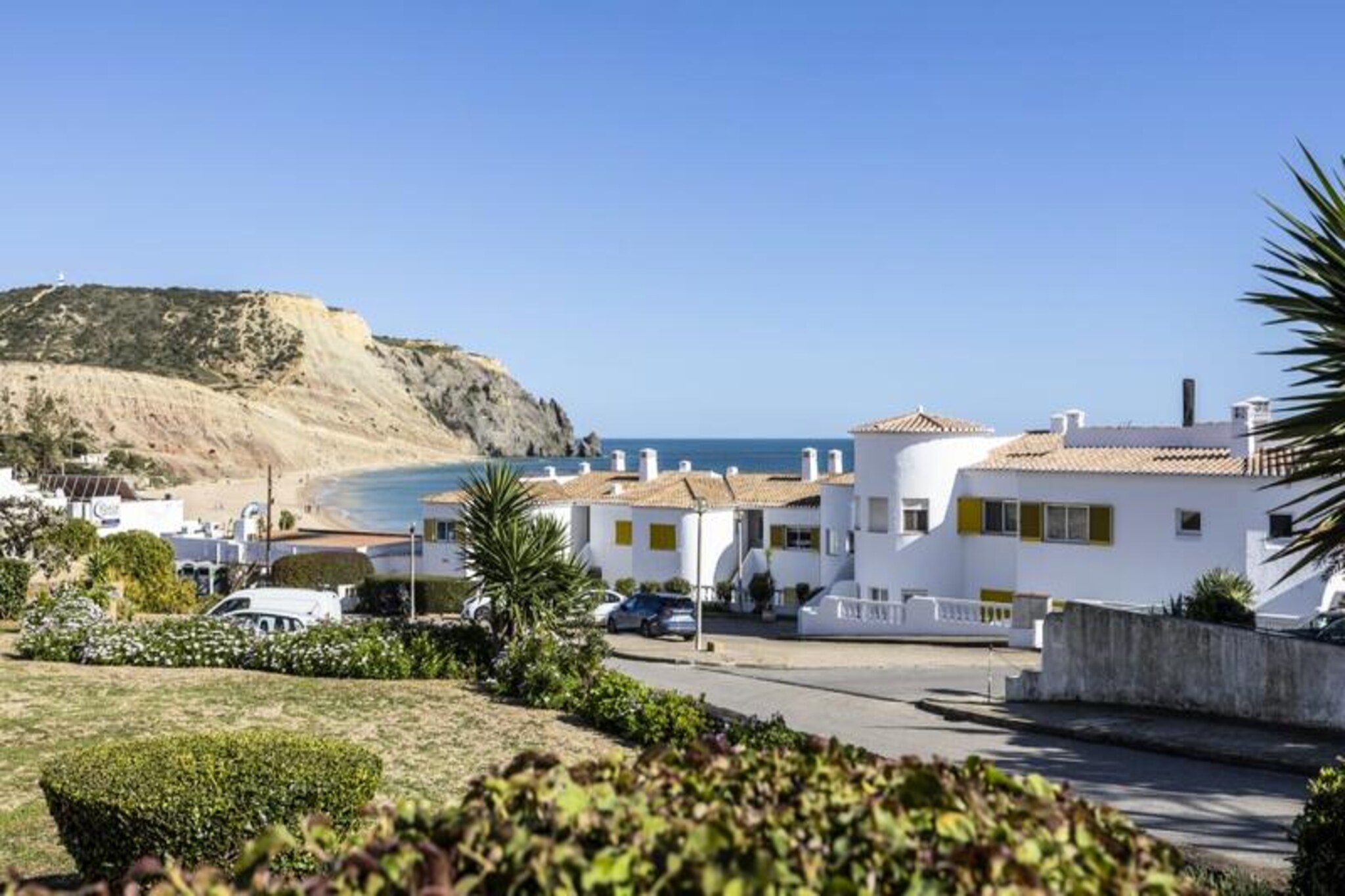 In the heart of the picturesque Praia da Luz, this modern Oceanview Dream apartment offers a serene escape just moments from the golden sands and vibrant promenade. Imagine waking up to the gentle sea breeze, stepping out onto your spacious terrace, and savoring your morning coffee as the town begins to stir. This peaceful retreat is perfect for couples seeking a blend of relaxation and adventure in one of the Algarve’s most charming seaside towns. 
 
 The apartment features a bright and airy open-plan living space, complete with large French doors that flood the room with natural light and lead to a furnished terrace ideal for al fresco dining. The separate bedroom boasts a comfortable double bed, while the renovated bathroom includes a sleek walk-in shower. The fully equipped kitchen allows you to prepare meals with ease, whether you’re whipping up a quick breakfast or a romantic dinner. Additional amenities such as a dishwasher, washing machine, and Smart TV ensure a comfortable and convenient stay. 
 
 Just a 2-minute walk from the beach and promenade, you’ll find yourself surrounded by local shops, supermarkets, and an array of restaurants and bars. For the adventurous, Praia da Luz offers excellent opportunities for surfing, snorkeling, and hiking along the dramatic cliffs. The nearby town of Lagos, with its historic charm, bustling marina, and famous cliffs, is only a 15-minute drive away, offering even more to explore. 
 
 Whether you’re here to unwind by the sea or discover the natural beauty of the Algarve, this apartment provides the perfect base for an unforgettable holiday. With its prime location, modern comforts, and tranquil ambiance, your dream getaway awaits.