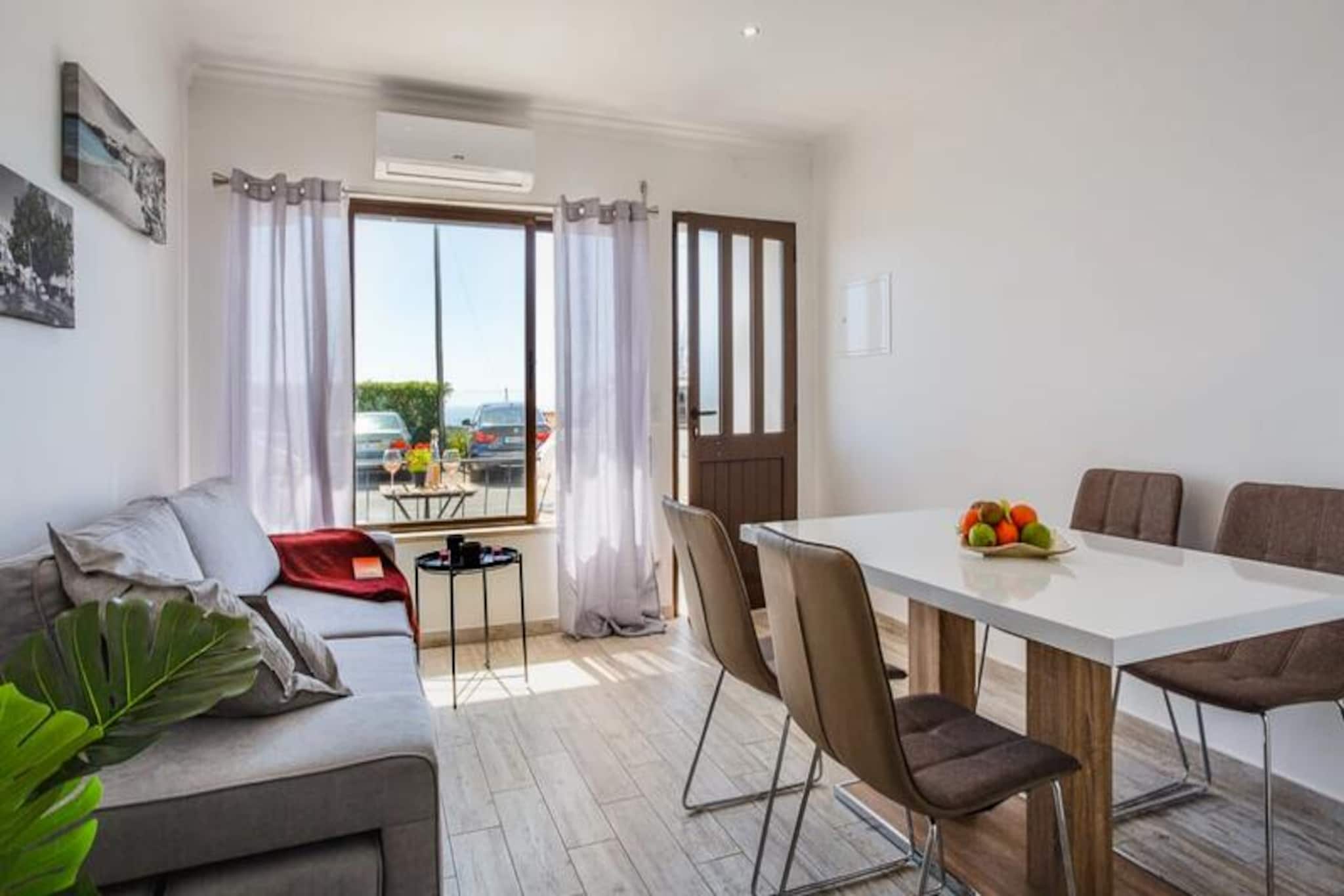 Bask in the golden glow of the Algarve in this charming one-bedroom apartment in Albufeira, where the sun-drenched coastline and vibrant local culture create the perfect backdrop for your holiday. Whether you're a couple seeking romance or a small family looking for a cozy retreat, this apartment offers a harmonious blend of comfort and convenience, just minutes from the region's famous beaches. Imagine waking up to the gentle warmth of the Portuguese sun, sipping coffee on your private balcony, and planning a day filled with seaside adventures or cultural discoveries. 

Step inside and you'll find a thoughtfully designed space that feels like home. The living room, bathed in natural light, features a plush sofa bed and stylish decor, creating an inviting atmosphere for relaxation. The bedroom is a serene haven, complete with a luxurious king-size bed dressed in high-quality linens. The fully equipped kitchen provides everything you need to prepare delicious meals, while the elegant dining area and balcony offer perfect spots to enjoy them. Modern amenities such as WiFi and a television ensure your stay is as comfortable as it is memorable.

Located just a short stroll from Albufeira's golden sands and crystal-clear waters, the apartment is perfectly positioned for exploring the best of the Algarve. Wander through the historic old town with its winding streets, lively squares, and charming shops, or venture to the bustling Oura Strip for vibrant nightlife and dining. For family fun, the popular Zoomarine park and nearby water parks are just a short drive away. Public transport is available, but renting a car is recommended to fully explore the region's treasures.

With its prime location, modern comforts, and the allure of the Algarve, this apartment is your gateway to an unforgettable holiday. Whether you're here to relax by the sea, dive into local culture, or embark on adventures, Albufeira awaits to make your stay truly special.