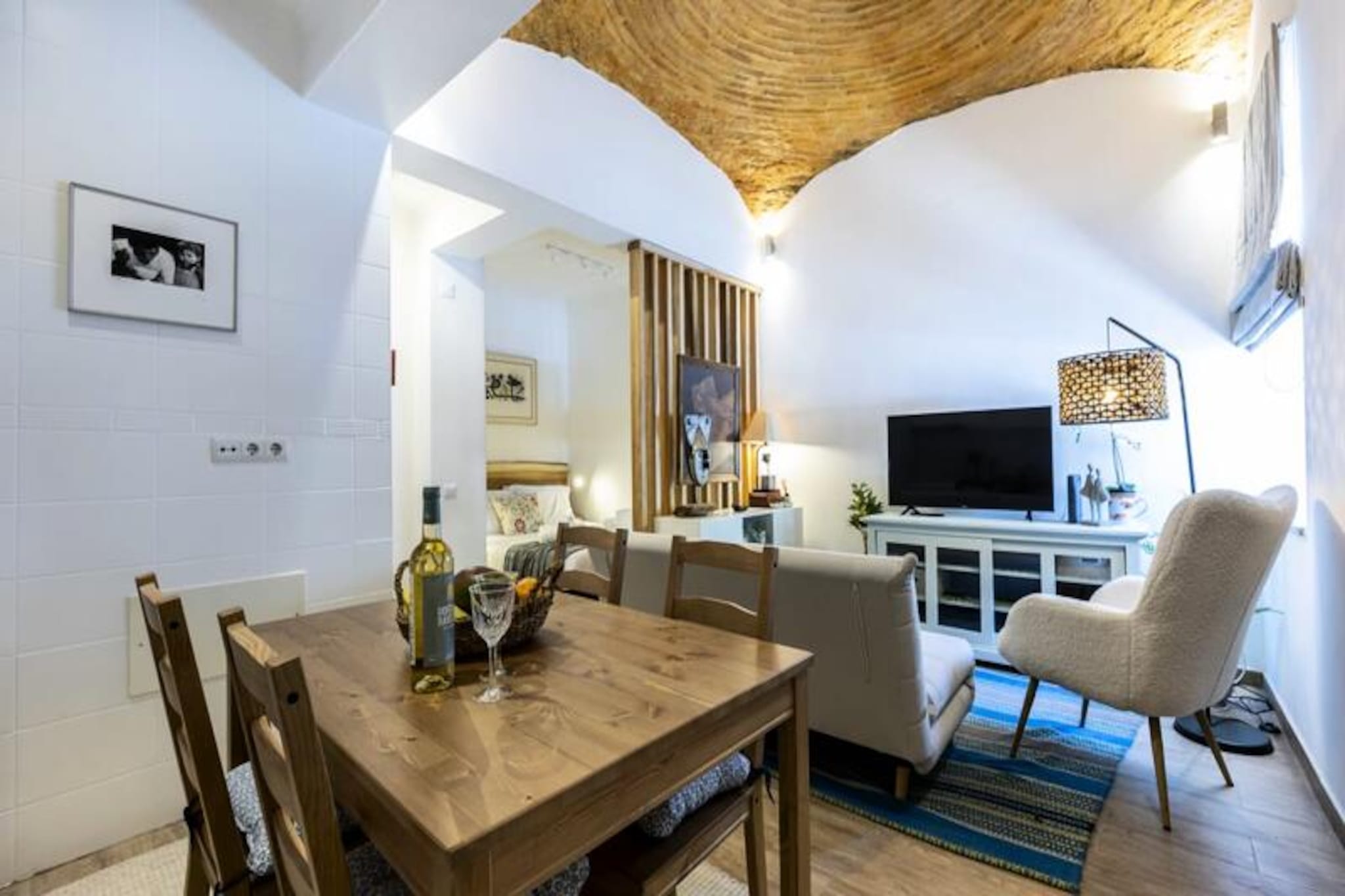 Step into the heart of Olhátildeo, where this thoughtfully designed apartment offers a perfect blend of modern comfort and authentic Portuguese charm. Tucked away in the historic center, this cozy retreat invites you to experience the vibrant culture, stunning landscapes, and warm hospitality of the Algarve. Whether you're strolling through cobblestone streets or savoring fresh seafood at a local eatery, every moment here feels like a celebration of life. 

Inside, the apartment maximizes space and functionality with a clever layout. The living area features a double bed discreetly separated by a sleek partition wall, creating a balance of openness and privacy. Upstairs, a tranquil single bedroom provides a peaceful escape. The fully equipped kitchen makes meal preparation a joy, whether you're crafting a quick snack or experimenting with ingredients from the nearby markets. The bathroom is modern and practical, ensuring a refreshing start or relaxing end to your day. 

The private terrace is a true highlight, shaded by a sail to protect you from the Algarve sun. Here, you can unwind with a book, sip a glass of wine, or simply enjoy the gentle coastal breeze. Just steps away, Olhátildeo's marina, historic landmarks, and eclectic restaurants await exploration. For those seeking adventure, ferries to the serene islands of Armona and Culatra are within easy reach, offering pristine beaches and unspoiled natural beauty. 

Whether you're a couple seeking a romantic getaway or a solo traveler in search of inspiration, this apartment is your gateway to the Algarve's treasures. With its central location, modern amenities, and undeniable charm, it promises an unforgettable stay.