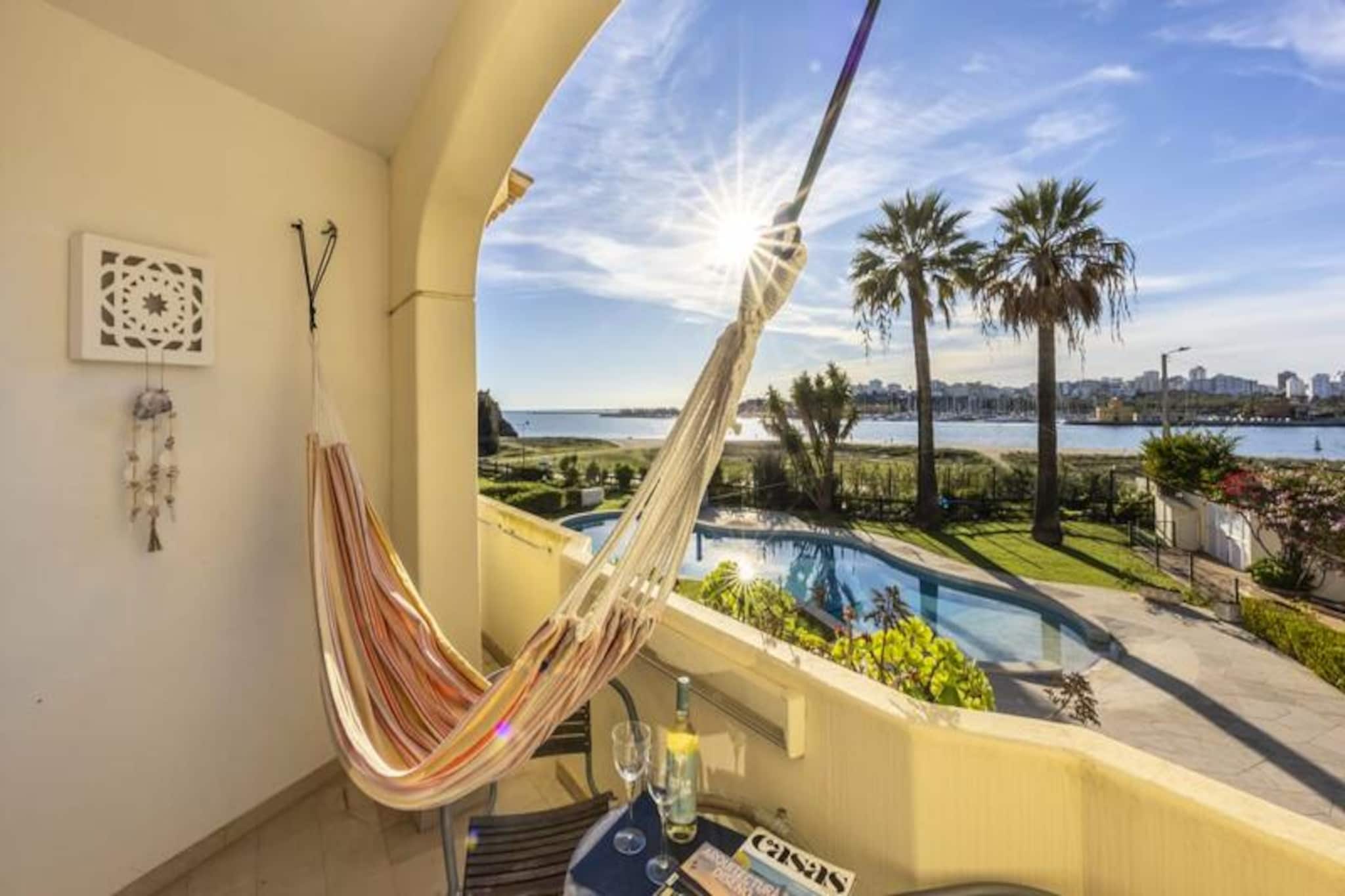 Imagine waking up to the gentle sound of waves and stepping out onto your private balcony to take in panoramic sea views that stretch towards Portimão and the Marina. This charming one-bedroom apartment at Clube Rio Ferragudo is a haven of tranquility and beauty, offering a perfect blend of comfort and coastal charm. Nestled within a boutique resort, you’ll also enjoy views of the lush gardens and a sparkling communal pool, creating an idyllic setting for your Algarve getaway. 

Designed to accommodate up to four guests, the apartment is ideal for couples, small families, or friends seeking a peaceful retreat. The interior features a serene bedroom with a king-size bed, a modern bathroom with a walk-in shower, and a cozy living and dining area. Both the bedroom and living room boast breathtaking sea views, while the fully equipped kitchen, complete with a filter coffee machine, ensures you can start each day with a fresh cup of coffee. Air conditioning and heating provide year-round comfort, and the balcony is the perfect spot to unwind with a glass of wine as the sun sets over the horizon.

Step outside and you’re just a short stroll from the sandy shores of Praia da Angrinha, where you can admire the historic São João do Arade castle. The vibrant Praia Grande, with its lively atmosphere and charming cafes, is also within walking distance. Explore the picturesque fishing village of Ferragudo, with its cobbled streets, whitewashed cottages, and the bustling Praça Rainha Dona Leonor, where you can savor delicious Portuguese cuisine. For more adventure, cross the river to Portimão or visit the iconic Praia da Rocha beach, known for its vibrant nightlife and stunning coastline.

Whether you’re looking to relax by the pool, explore the Algarve’s stunning beaches, or indulge in local culture and cuisine, this apartment offers the perfect base for an unforgettable holiday. With Faro Airport just 50 minutes away and easy access to nearby attractions, your dream escape awaits.