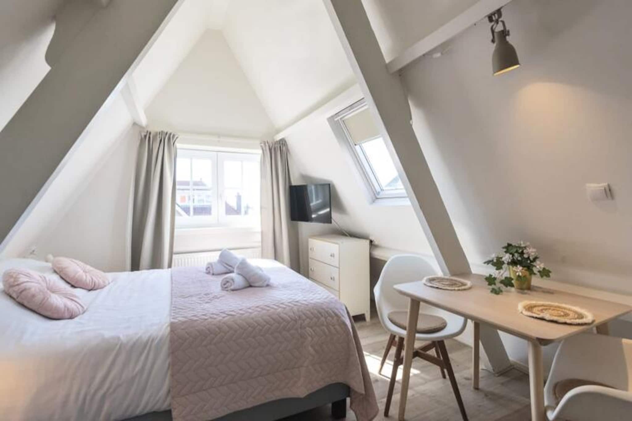 Step into the serene charm of Studio 3 at Boutique Pension Bennekom in Zandvoort, where modern comfort meets seaside tranquility. Just a 5-minute stroll from the sandy shores, this romantic attic studio is perfect for couples seeking a cozy retreat. The property is nestled in a residential area, offering a peaceful ambiance while being close to lively beach bars, restaurants, and the vibrant town center, which is only a 10-minute walk away. Whether you’re looking for a quiet escape or an active seaside adventure, this studio is your ideal base. \n\nDesigned with Italian-inspired modernity, Studio 3 offers a functional yet stylish space on the second floor, accessible only by stairs. The studio features a comfortable bed consisting of two single box-spring mattresses that can be separated, a charming dining area, and a fully equipped kitchenette with a two-burner electric hob, oven, coffee maker, kettle, and small refrigerator. Recently renovated, the studio ensures a relaxing stay with Wi-Fi, television, linens, and towels provided. The private shower and separate toilet add to the convenience, creating a home away from home for your seaside getaway.\n\nZandvoort offers a wealth of activities to suit every traveler. Explore the nearby national parks, De Waterleidingduinen and Kennemerduinen, perfect for hiking, cycling, and spotting wildlife. For thrill-seekers, the famous Circuit Park Zandvoort is just 1.2 km away, hosting exciting events like the Historic Grand Prix and DTM. Learn to surf or kitesurf, enjoy mountain biking, or simply unwind at one of the many beach clubs. Zandvoort’s naturist beach adds a unique touch to this diverse destination.\n\nWith Zandvoort aan Zee train station just 15 minutes away, you can easily combine your seaside escape with a city adventure in Amsterdam or Haarlem. Whether you’re drawn to the golden sands or the cultural treasures of the nearby cities, Studio 3 provides the perfect setting for unforgettable memories.