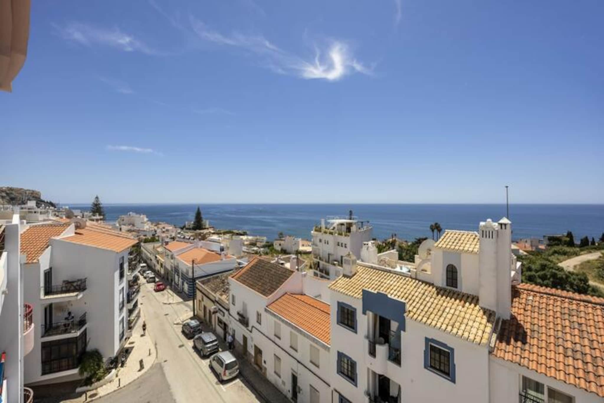 Imagine waking up to the sound of waves gently lapping the shore, with the golden sands of Praia da Luz just a two-minute stroll away. This top-floor retreat is a haven of tranquility, offering breathtaking views of the Atlantic Ocean and a serene escape from the everyday. Nestled in the heart of Luz, this apartment is the perfect base for couples seeking a romantic getaway or anyone looking to recharge by the sea.
Spanning 60 m², this bright and airy one-bedroom apartment is thoughtfully designed for comfort and relaxation. The living and dining areas open onto a private south-facing balcony, where you can savor your morning coffee or unwind with a glass of wine as the sun sets over the ocean. The fully equipped kitchen includes everything you need, from a gas stove and oven to a dishwasher and washing machine, making it easy to prepare meals with fresh local ingredients. The bedroom, with its cozy double bed, is bathed in natural light and offers stunning sea views, while the modern bathroom features a bathtub, bidet, and all the essentials for a comfortable stay. High-speed fiber optic internet, a TV with Chromecast, and a HiFi system ensure you stay connected and entertained throughout your visit.
Step outside, and you’ll find yourself in the charming village of Praia da Luz, where shops, restaurants, and cafes are just a short walk away. The nearby beach is perfect for sunbathing, swimming, or trying your hand at water sports. For those looking to explore further afield, the historic city of Lagos is just 10 km away, offering a vibrant marina, cobbled streets, and dramatic cliffs to discover by boat or kayak. Whether you’re here to relax on the beach, explore the Algarve coast, or indulge in local cuisine, this apartment provides the ideal starting point for your adventures.
With its unbeatable location, modern amenities, and stunning views, this apartment is more than just a place to stay – it’s a destination in itself. Let the beauty of Praia da Luz captivate you and create memories that will last a lifetime.