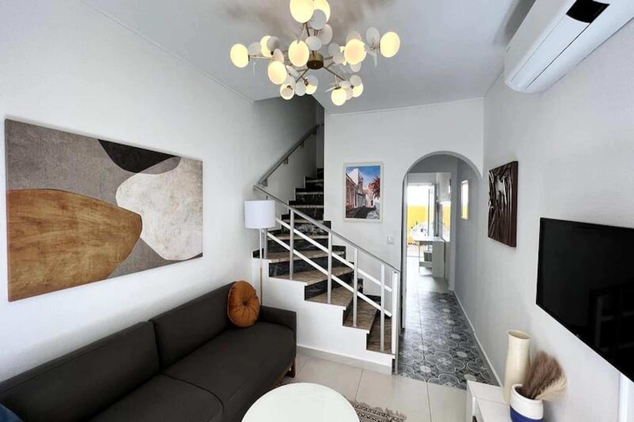 In the heart of Lagos' historic center, this charming townhouse invites you to experience the perfect blend of tradition and modern comfort. Set on a quiet cobbled street surrounded by classic Portuguese architecture, this home offers a serene retreat just steps away from the vibrant energy of the city. Whether you're strolling to the marina, discovering local cafes, or enjoying the lively nightlife, every corner of Lagos is at your fingertips. The townhouse provides an authentic Portuguese ambiance that will make your stay unforgettable. 

Accommodating up to four guests, the property features two cozy bedrooms with double beds, a full bathroom, and an additional WC. The original marble staircase adds a touch of historical elegance, while modern amenities such as air conditioning, heating, and a fully equipped kitchen ensure your comfort. Relax in the sunny patio, a perfect spot to unwind after a day of exploring. The house is thoughtfully designed to offer both privacy and convenience, making it ideal for families or small groups of friends. 

Just a short walk away, you'll find the best bakery in town, All Things Dough, as well as the bustling farmers' markets on Wednesdays and Saturdays. The nearby marina area is a hub of activity, offering restaurants, bars with live music, and a large supermarket. For adventure seekers, Lagos is renowned for its stunning cliffs and pristine beaches, perfect for kayaking, paddleboarding, or boat trips. The historic center brims with shops, local eateries, and friendly locals eager to share their culture. 

This townhouse is more than just a place to stay; it's your gateway to the vibrant charm of Lagos. Whether you're a food lover, a history enthusiast, or an outdoor adventurer, this home offers the perfect base for your Portuguese getaway.