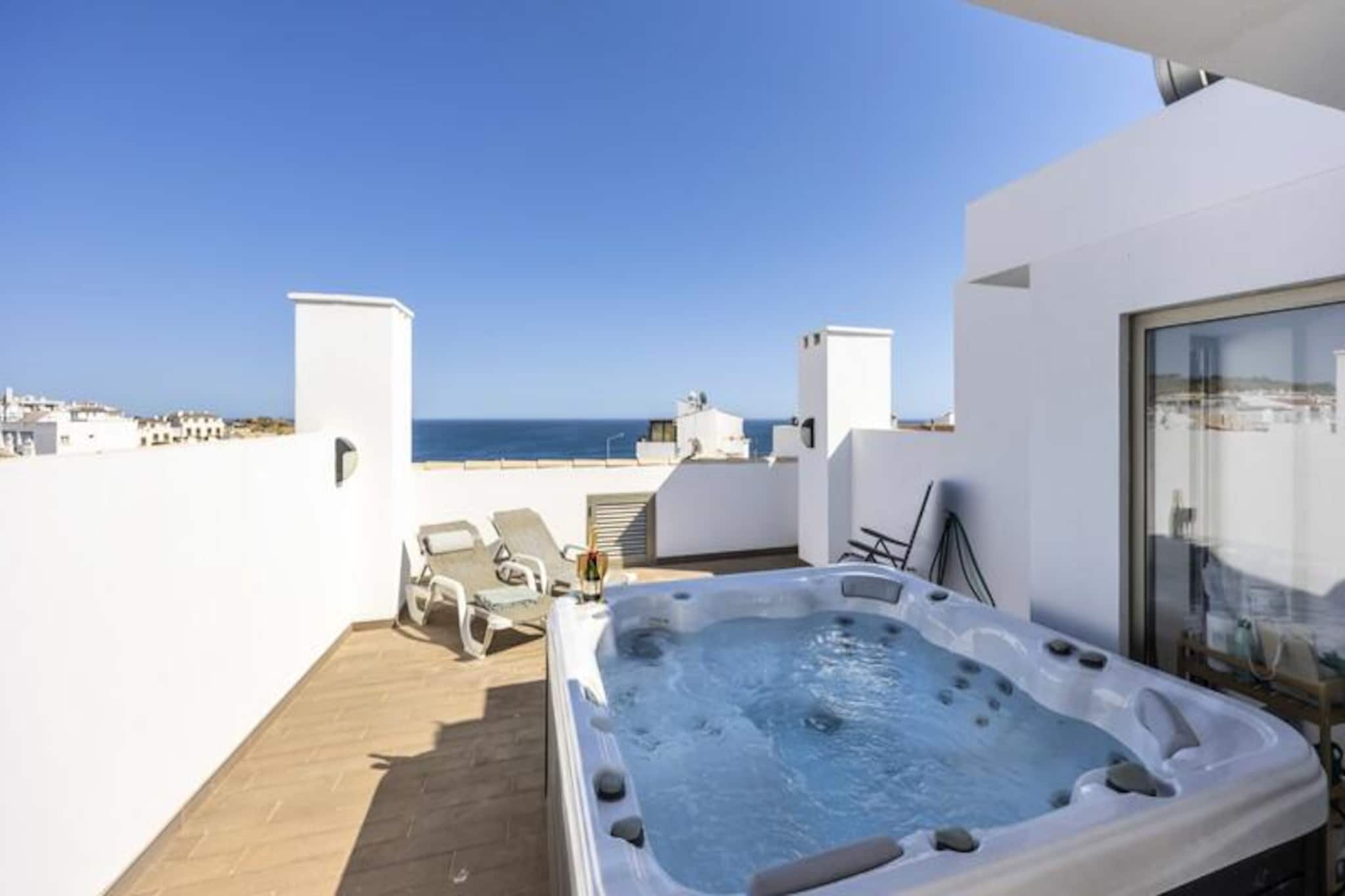Awaken your senses in the tranquil fishing village of Burgau, where this stunning modern apartment offers a perfect blend of comfort and seaside charm. Just a 3-minute stroll from the golden sands of Burgau Beach, this property invites you to immerse yourself in the beauty of the Algarve. Wander through cobbled streets adorned with bougainvillea, and let the gentle sea breeze guide you to the crystal-clear waters of the Atlantic Ocean. 
 
 This second-floor apartment, designed for two, exudes modern elegance. The bright bedroom features a luxurious king-size bed, air conditioning, and a television for your comfort. The open-plan living area is perfect for relaxing, with a fully equipped kitchen, a cozy dining space, and a lounge that opens onto a south-facing balcony. Here, you can enjoy breathtaking sea views, savor a barbecue, or unwind in the outdoor seating area. For the ultimate indulgence, ascend to your private rooftop terrace, complete with sun loungers, a dining area, and a jacuzzi for stargazing under the Algarve sky. 
 
 Guests also have access to a shared swimming pool and secure parking, ensuring a stress-free stay. The apartment’s location is ideal for exploring the Algarve, with world-class surfing beaches, scenic hiking trails, and prestigious golf courses just a short drive away. Burgau itself is a haven of authentic Portuguese charm, offering delightful restaurants, quaint bars, and a peaceful atmosphere. 
 
 Whether you’re seeking relaxation or adventure, this apartment provides an unforgettable base for your Algarve escape. Let the soothing rhythm of the ocean and the allure of Burgau create memories to cherish forever.