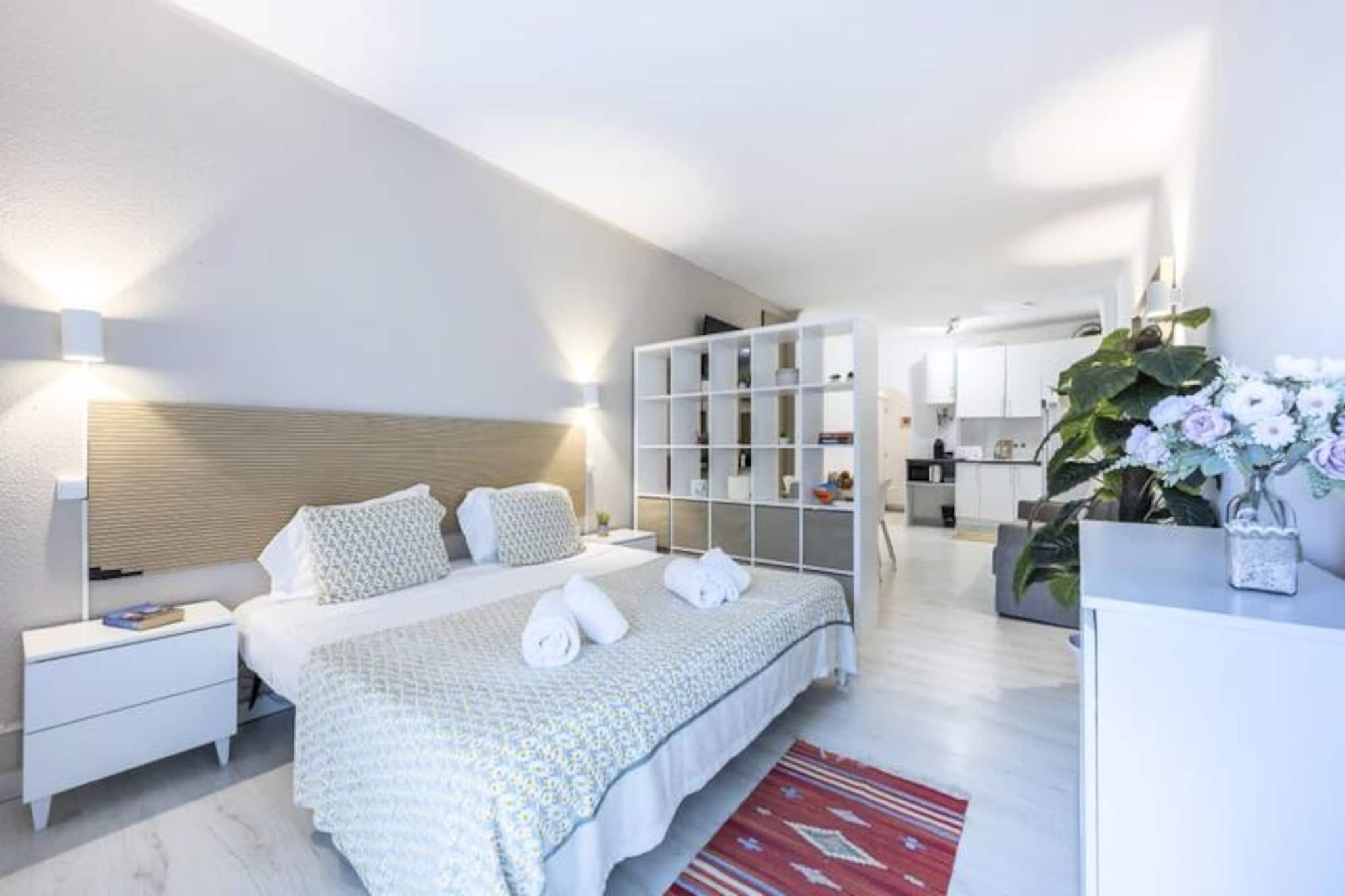 Step into a world of comfort and relaxation in this delightful studio apartment in Albufeira, Portugal. Located in the sought-after Edificio Vila Magna, this charming retreat is perfect for couples seeking a peaceful getaway. Wake up to the gentle sunlight streaming through your private northwest-facing balcony and enjoy the convenience of being just moments away from the vibrant heart of Albufeira. Whether you're here for the beaches, nightlife, or simply to unwind, this property offers the ideal base for your Algarve adventure.\n\nInside, the studio is thoughtfully designed for both style and practicality. A small hallway leads to a modern bathroom, while the open-plan living area features a fully equipped kitchen, a cozy sofa, and a queen-size bed. Air conditioning ensures your comfort during warm summer nights, and the balcony provides a tranquil spot to sip your morning coffee or enjoy a quiet evening. Guests also benefit from access to excellent building amenities, including a swimming pool and a gym. The pool is accessible with a small deposit for a card, while the gym requires a nominal fee at reception. For those traveling by car, garage parking is available for an additional daily fee.\n\nAlbufeira is renowned for its stunning beaches, lively restaurants, and bustling nightlife. The Old Town offers a charming atmosphere with bars and eateries, while \