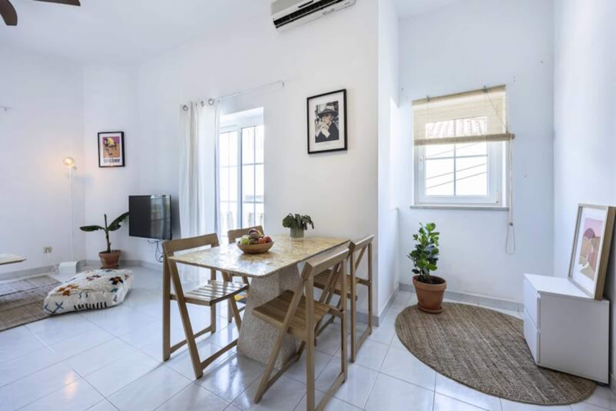 In the heart of Lagos' historic old town, this stylish one-bedroom apartment offers the perfect retreat for travelers seeking both charm and convenience. With its minimalist design and cozy atmosphere, it’s an inviting space where you can unwind after exploring the vibrant streets, golden beaches, and stunning cliffs that make Lagos a top destination. Whether you’re a surfer chasing the perfect wave or a couple looking for a romantic getaway, this apartment provides an ideal base for your adventures. 
 
 The apartment welcomes you with a bright and airy living room, complete with air conditioning, a ceiling fan, and a comfortable sofa for relaxing evenings. The adjoining dining area is perfect for enjoying meals prepared in the fully equipped kitchen, which includes everything you need for a hassle-free stay. Step out onto the private balcony to sip your morning coffee while soaking in the lively street views. The bedroom, featuring a double bed and a fan, ensures restful nights, while the bathroom offers a bathtub for a relaxing soak after a day of exploration. 
 
 Located just steps from Lagos’ best cafes, bars, and cultural attractions, this apartment places you at the center of it all. Wander through the charming cobblestone streets, indulge in fresh seafood at local restaurants, or take a short walk to the beach to bask in the Algarve sun. For the adventurous, boat tours, kayaking, and paddleboarding along the dramatic coastline are must-try experiences. 
 
 Whether you’re here to relax, explore, or ride the waves, this apartment offers a stylish and functional space to make your stay unforgettable. With its unbeatable location and thoughtful amenities, it’s the perfect choice for your Lagos escape.
