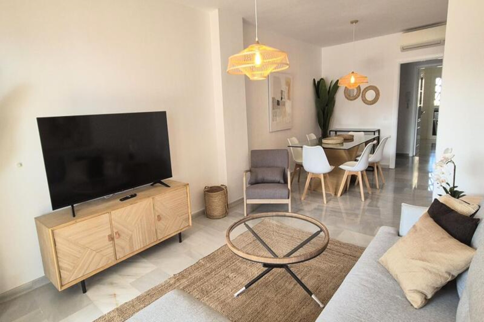 Imagine waking up to the gentle sound of waves and the golden hues of the Mediterranean sun streaming through your window. This elegant two-bedroom apartment, located in the prestigious Mi Capricho residence in Calahonda, Mijas Costa, offers the perfect blend of comfort, exclusivity, and a prime beachfront location. Whether you're seeking a peaceful retreat or an active holiday, this property promises an unforgettable stay on the Costa del Sol. \n\nStep inside and discover a thoughtfully designed space with two bright and spacious bedrooms, each featuring built-in wardrobes. The master bedroom opens onto a private terrace, perfect for morning coffee with a view, while the second bedroom offers a partial glimpse of the sea. Two modern bathrooms with walk-in showers ensure convenience for all guests. The large living and dining area seamlessly connects to a glass-enclosed terrace, ideal for year-round enjoyment. The separate, fully equipped kitchen includes everything you need, from an oven and ceramic hob to a dishwasher and washing machine. Reversible air conditioning in all rooms ensures your comfort in every season.\n\nMi Capricho is more than just a residence; it’s a lifestyle. Enjoy two saltwater swimming pools, beautifully landscaped gardens, a children's playground, and a seasonal beach bar. With direct access to the seafront promenade and beach, you can spend your days soaking up the sun or exploring the coastline. Sun loungers are available at the pools from mid-May, adding an extra touch of luxury to your stay.\n\nIdeally situated between Marbella and Fuengirola, this apartment is surrounded by amenities including supermarkets, restaurants, golf courses, and shops. Malaga Airport is less than 30 minutes away, making your arrival and departure seamless. Whether you're here to relax or explore, this beachfront haven offers everything you need for a memorable holiday. Your Costa del Sol escape begins here.
