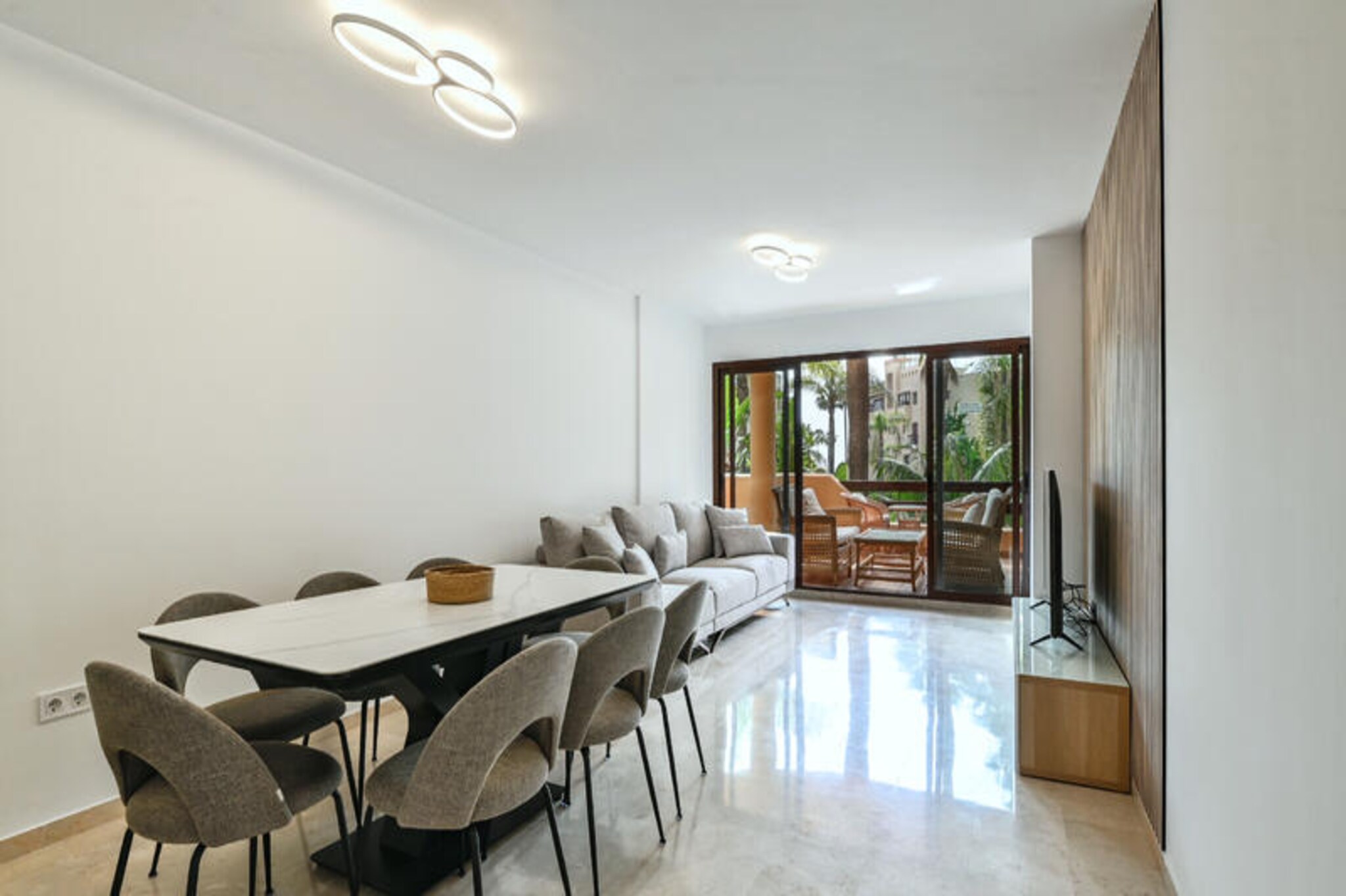 Imagine waking up to the gentle sound of waves and stepping onto your private terrace to enjoy the Mediterranean sun. This exquisite apartment in the prestigious Terrazas de Costalita residence offers an unparalleled holiday experience right on Estepona's golden beach. Surrounded by lush gardens and with direct access to the sea, this is the perfect retreat for those seeking both relaxation and sophistication on the Costa del Sol. Located next to the renowned Villa Padierna tennis club and the elegant Mett Hotel, the property combines convenience with luxury.
The apartment boasts a modern, sunlit interior with three spacious bedrooms, each equipped with built-in wardrobes for ample storage. Two of the three bathrooms are en suite, ensuring privacy and comfort, while the third includes a bidet for added convenience. The heart of the home is the stylish living-dining area, featuring a dining table for eight and a 55-inch Smart TV for your entertainment. Step out onto the south-facing terrace to enjoy partial views of the Mediterranean and the serene communal pool, a perfect spot for morning coffee or evening relaxation.
The fully equipped kitchen is a dream for culinary enthusiasts, complete with modern appliances and all the utensils you need to prepare your favorite dishes. Central air conditioning ensures comfort year-round, and high-speed private Wi-Fi keeps you connected. Additional amenities include a washing machine, dryer, and a private underground parking space for hassle-free arrivals. The residence also features a communal swimming pool, a small gym, and private beach access, offering everything you need for a memorable stay.
With its prime location, you'll find a variety of restaurants, supermarkets, and essential services just a stone's throw away. Guests can also enjoy the Mett Hotel's exclusive pools and dining options during the summer season. Whether you're looking to unwind by the sea, explore Estepona's vibrant culture, or indulge in fine dining, this apartment provides the perfect base for an unforgettable holiday. Book your stay now and create lasting memories on the Costa del Sol.