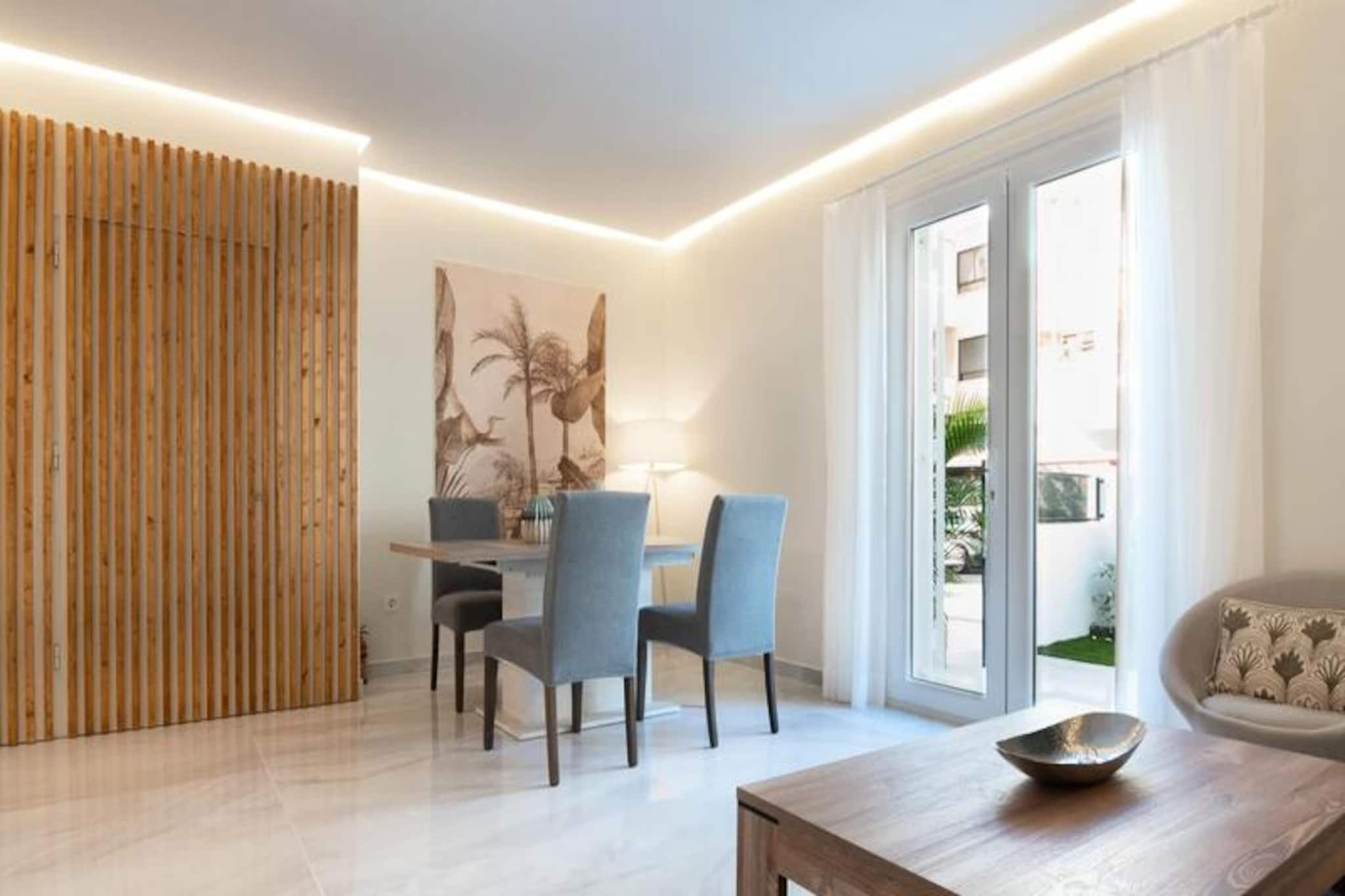 Step into a world of Mediterranean elegance with this stunning ground-floor holiday apartment in the heart of Marbella. Just moments from the marina and a short stroll to the golden sands of the beach, this property offers the perfect blend of luxury, comfort, and convenience. Whether you’re exploring the historic center, less than a 10-minute walk away, or soaking up the vibrant atmosphere of Marbella’s iconic Costa del Sol, this apartment is your gateway to an unforgettable escape.\n\nThe apartment welcomes you with two private terraces, each thoughtfully designed for relaxation and leisure. The elegant living and dining area features contemporary decor, a Smart TV, and an open-plan layout that seamlessly connects to a fully equipped kitchen with high-end appliances. Perfect for extended stays, the kitchen opens onto a second terrace—a tranquil oasis complete with a chill-out zone, outdoor dining area, and lush artificial grass for serene moments under the sun.\n\nThe south-facing master bedroom boasts a plush double bed, a television, and direct terrace access, complemented by a semi-open en suite bathroom with sleek modern finishes and a spacious shower. The second bedroom, equally bright and inviting, offers two single beds and ample storage space. A second bathroom with a functional, stylish shower ensures comfort for all guests. High-speed Wi-Fi, air conditioning, and a security alarm provide peace of mind and year-round comfort.\n\nSituated steps from Marbella’s main attractions and the beach, this apartment is ideal for families, couples, or friends seeking a luxurious yet lively Costa del Sol experience. Book now and immerse yourself in the charm, culture, and beauty of Marbella!