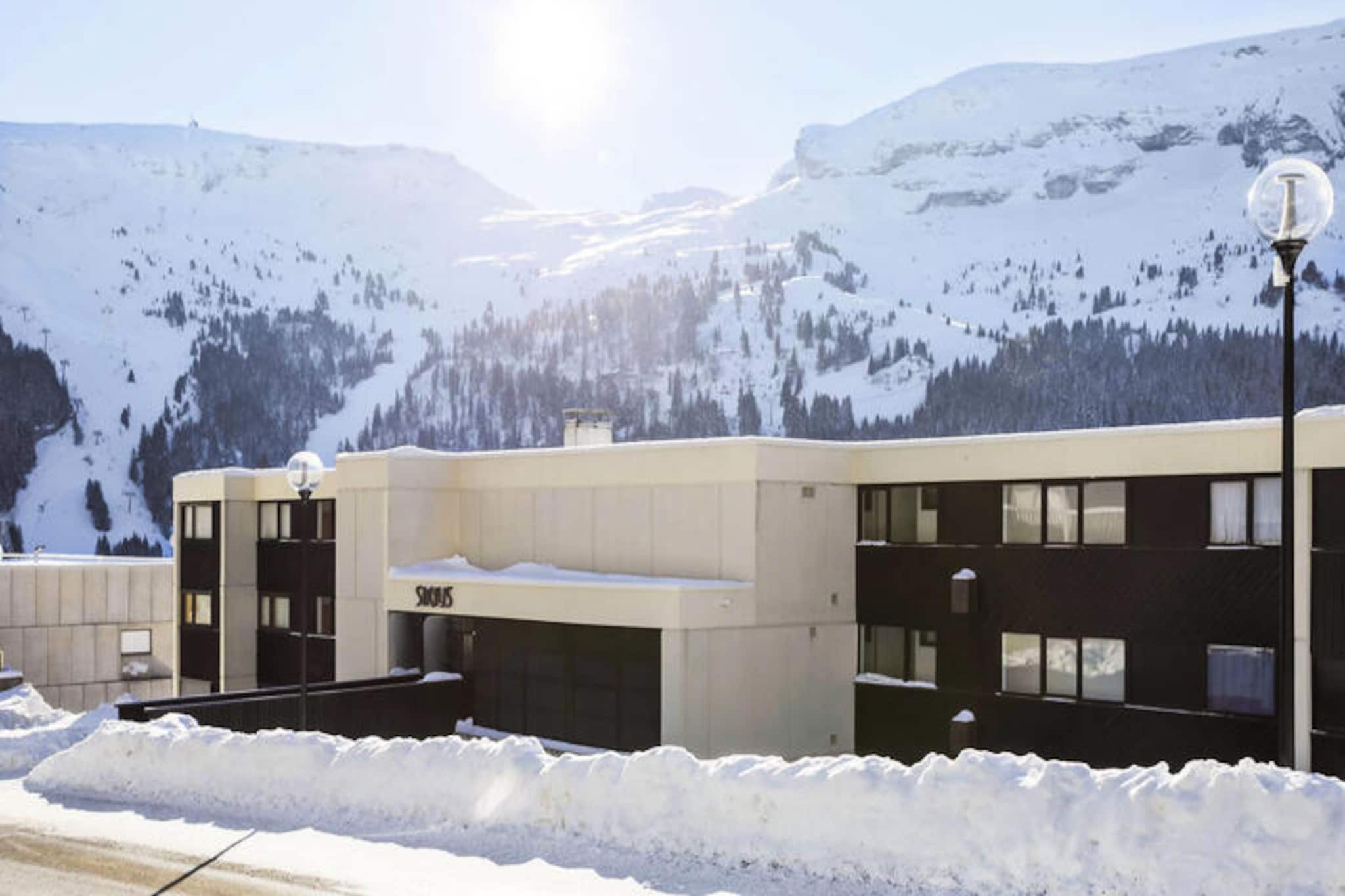 In the heart of the serene Flaine Forest district, the Sirius Residence invites you to immerse yourself in the beauty of the French Alps. Surrounded by lush greenery and offering breathtaking views, this peaceful retreat is perfect for those seeking both tranquility and adventure. The residence combines the charm of alpine living with the convenience of nearby shops and services, ensuring a seamless holiday experience. 

The studio, designed for up to four guests, features a cozy living area, a well-equipped kitchen, two sleeping alcoves, a bathroom, and a separate toilet. With approximately 25 m² of space, it’s ideal for couples or small families. The Maeva Home Comfort label guarantees good value for money, offering essential comforts in a well-maintained setting. Included amenities such as a cleaning kit and the option for additional services like end-of-stay cleaning ensure a stress-free stay. 

Located just 500 meters from the ski lifts, you’ll have easy access to the expansive Grand Massif ski area, renowned for its diverse slopes and stunning alpine scenery. For added convenience, a free Skibus shuttle stops right at the foot of the residence, making your journey to the slopes effortless. Whether you’re here to ski in winter or hike in summer, the location offers endless opportunities for outdoor exploration. 

Choose the Sirius Residence for a holiday where comfort meets adventure. With its prime location, welcoming atmosphere, and access to one of the most beautiful ski areas in France, it’s the perfect base for creating unforgettable memories in the Alps.