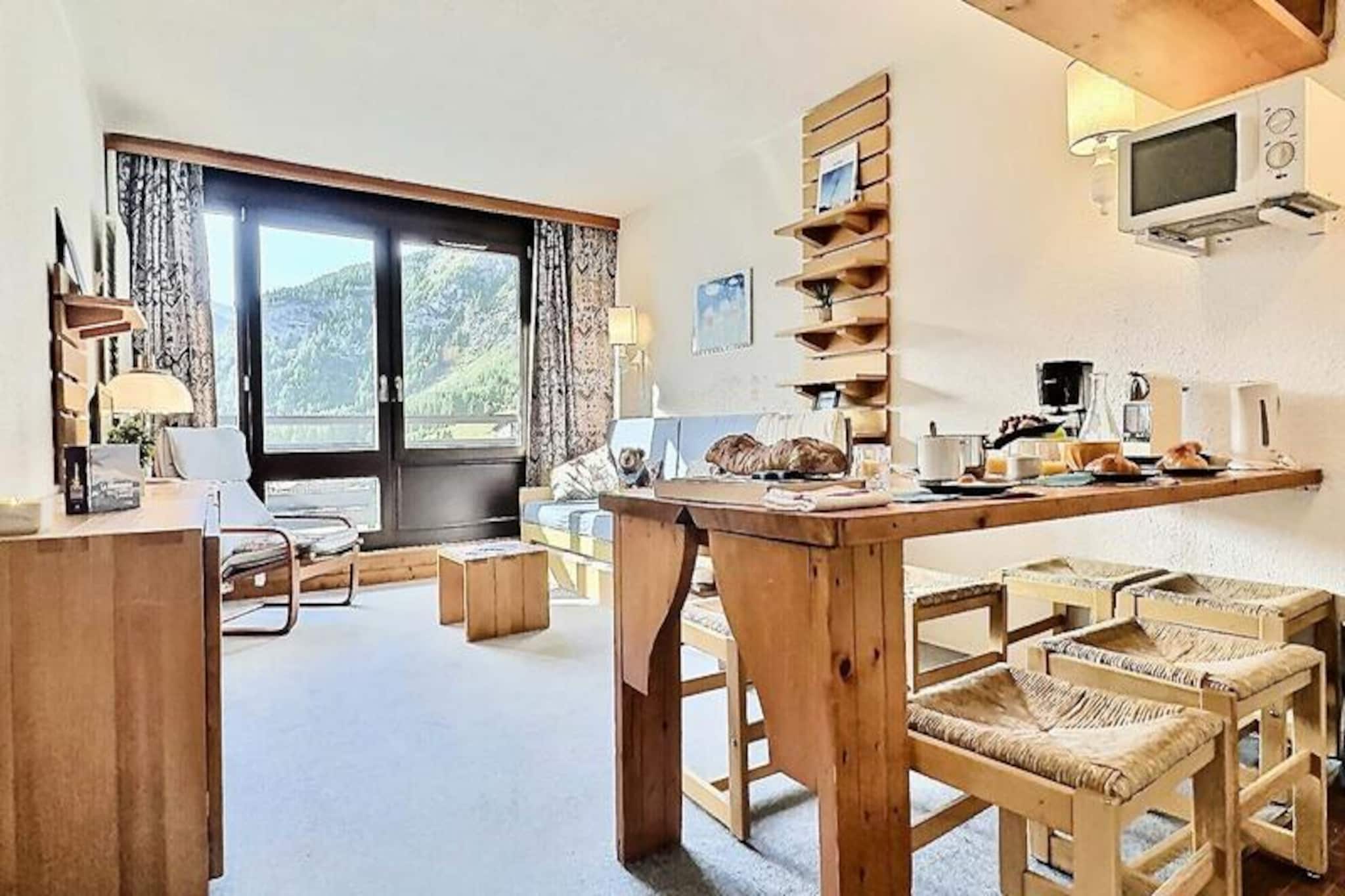 High above the charming alpine village of La Daille, this cozy one-bedroom apartment invites you to experience the magic of Val d'Isère in every season. From its elevated position on the 8th floor, the property offers breathtaking views of the surrounding valley, majestic mountains, and pristine ski slopes. Whether you’re here for thrilling winter sports or tranquil summer hikes, this retreat is the perfect base for your alpine adventures.
Inside, the 40m² apartment is thoughtfully designed to accommodate up to five guests. The living room features comfortable pull-out beds, while the bedroom offers a set of three bunk beds, ideal for families or small groups. A fully equipped kitchen with an induction cooktop, oven, microwave, dishwasher, and refrigerator ensures you can prepare hearty meals after a day of exploration. The apartment also includes a bathroom with a bathtub, a separate toilet, and two private balconies—one facing south for sunlit mornings and panoramic views, and the other facing north for a quieter retreat. Modern amenities like a television and a ski locker add to your convenience.
Step outside, and you’ll find yourself in a ski-in/ski-out paradise, with immediate access to the world-class slopes of Val d'Isère. The nearby \