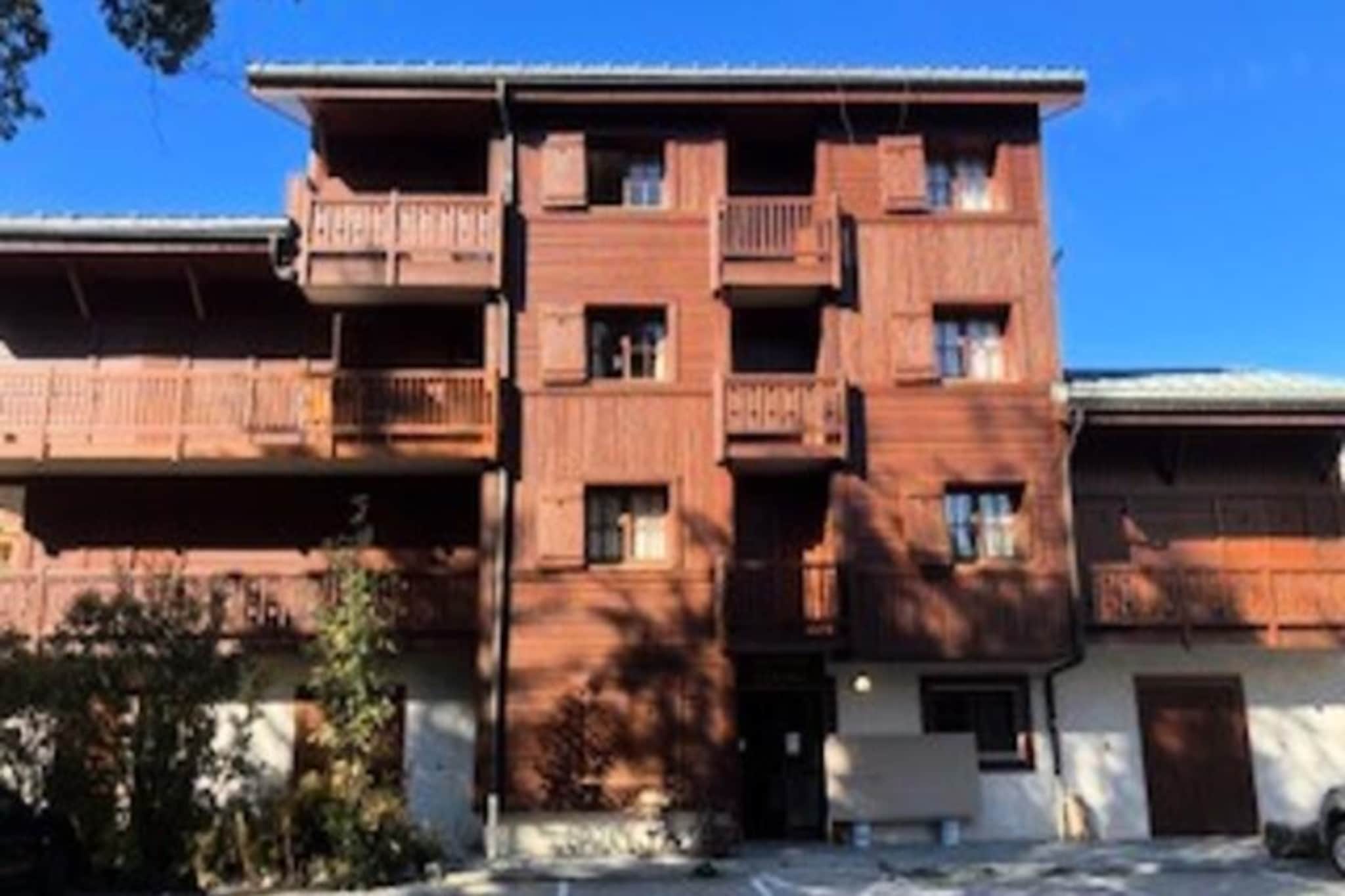 Amid the serene charm of Les Arcs 1800, this spacious 75 m² apartment offers a tranquil retreat for mountain enthusiasts and families alike. Situated on the first floor of a quaint three-story building, it combines peaceful surroundings with convenient access to the resort's amenities and ski lifts, ensuring a seamless alpine experience. From its southwest-facing balcony, soak in the golden hues of the setting sun while breathing in the crisp mountain air—a perfect backdrop for relaxation after a day of adventure. \n\nInside, the apartment is thoughtfully designed to cater to comfort and practicality. The living room features cozy wooden sofas, an armchair, and a dining area with a rustic wooden table and chairs, creating a warm and inviting space for shared moments. The fully equipped kitchen boasts modern appliances, including a refrigerator with freezer compartment, oven, microwave, ceramic cooktop, toaster, kettle, filter coffee maker, and dishwasher, making meal preparation effortless. Sleeping arrangements include a mountain-style alcove with bunk beds, a bedroom with a double bed, and another with two single beds, ensuring restful nights for up to six guests. A bathroom with a bathtub and sink, along with a separate toilet, completes the layout. \n\nBeyond the apartment, Les Arcs 1800 beckons with its vibrant yet relaxed atmosphere. Whether you're here for skiing on world-class slopes or exploring scenic hiking trails in summer, the resort offers endless opportunities for outdoor fun. Nearby shops, restaurants, and ski schools add convenience, while the breathtaking vistas of the French Alps provide a stunning backdrop to every activity. \n\nChoose this charming apartment for its blend of comfort, location, and authentic alpine ambiance. Whether you're seeking thrilling winter sports or tranquil summer escapes, it promises unforgettable memories in the heart of the mountains.