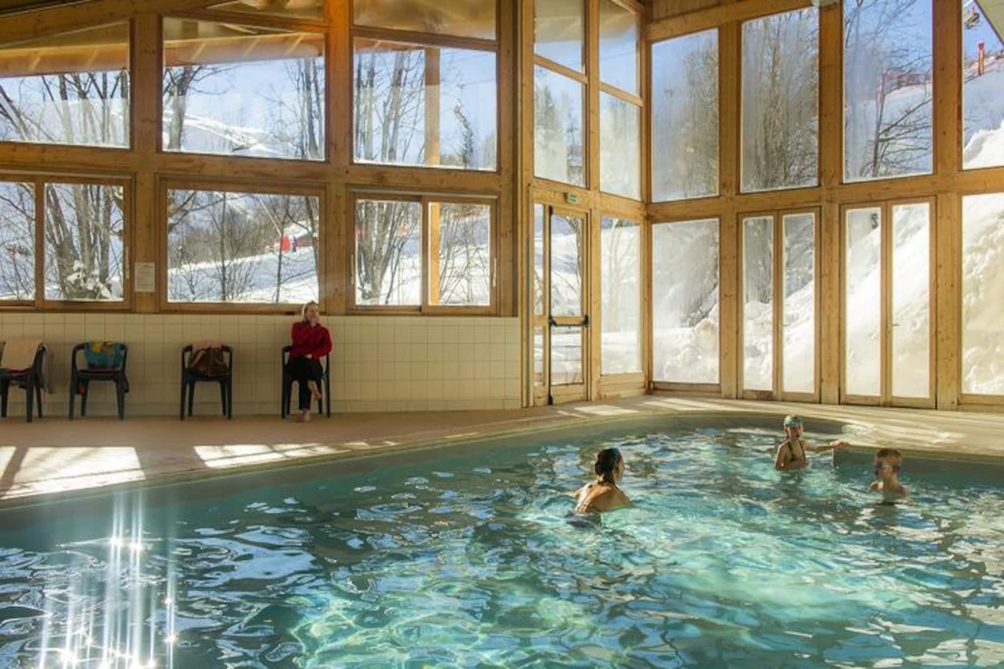 High in the breathtaking French Alps, Résidence Le Balcon des Neiges*** offers a cozy retreat just 150 meters from the slopes, where winter adventures and alpine charm converge. Imagine stepping out of your door and being moments away from the vast Sybelles ski area, with its 310 km of slopes and stunning panoramic views. Whether you're here for thrilling descents or serene snowshoeing trails, this location promises unforgettable mountain experiences. 

The residence combines comfort and convenience, featuring a heated indoor pool and sauna for ultimate relaxation after a day on the slopes. Challenge friends to a game of billiards or enjoy fresh pastries with the on-site bakery service. The apartments are thoughtfully designed, with a pull-out sofa bed, an alcove with bunk beds, and a fully equipped kitchenette, making it perfect for families or small groups. Modern amenities, including WiFi and a TV, ensure a comfortable stay, while pet-friendly options allow you to bring your furry companions along. 

Beyond the residence, the lively resort offers a range of activities, from torchlit ski descents and fireworks to festive Christmas events with magic shows and ice sculpting. The nearby shops, restaurants, and free shuttle service make it easy to explore the area. At 2,600 meters above sea level, the Sybelles ski area is a paradise for skiers and nature lovers alike. 

Whether you're seeking adventure or relaxation, Résidence Le Balcon des Neiges*** is your gateway to an enchanting alpine escape, where every moment is steeped in the beauty of the mountains.