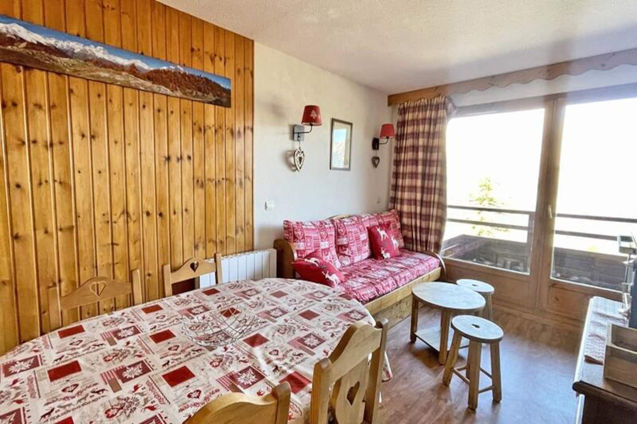 High above the charming village of Puy Saint Vincent 1800, the Residence Dame Blanche invites you to experience the perfect alpine getaway. With direct access to the ski slopes, this property offers a seamless blend of convenience and comfort, making it ideal for both winter sports enthusiasts and summer adventurers. Imagine waking up to the crisp mountain air and stepping onto your private balcony to take in breathtaking views of the surrounding peaks. Whether you're here to carve through fresh powder or explore scenic hiking trails, this residence places you at the heart of the action. \n\nInside, the apartment is thoughtfully designed to accommodate up to six guests. The cozy living room features a pull-out sofa bed, a dining area, and a flat-screen TV, creating a welcoming space for relaxation after a day outdoors. The well-equipped kitchen includes modern amenities such as a microwave, dishwasher, and coffee maker, ensuring you have everything needed to prepare delicious meals. Two separate sleeping areas—a bedroom with a double bed and a cabin room with twin beds—provide comfort and privacy for families or groups. Additional conveniences include a separate bathroom and WC, as well as free WiFi throughout the property.\n\nThe residence boasts a heated outdoor pool open during the summer months, perfect for unwinding under the alpine sun. A sauna is available by reservation for those seeking extra relaxation, while practical amenities like a coin-operated laundromat and ski equipment rental shop ensure a hassle-free stay. At the foot of the residence, you'll find a restaurant, snack bar, and bakery offering local delights, along with a grocery store for essentials.\n\nWhether you're drawn to the thrill of skiing, the tranquility of mountain landscapes, or the charm of Puy Saint Vincent, Residence Dame Blanche offers an unforgettable escape. Let the beauty of the French Alps inspire your next adventure.