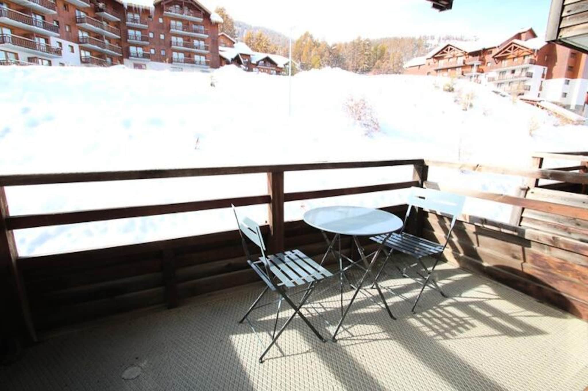 High above the picturesque slopes of Puy Saint Vincent 1800, this charming apartment in the La Dame Blanche residence invites you to immerse yourself in the serenity of the French Alps. With breathtaking views and direct access to the ski slopes, it’s a haven for winter sports enthusiasts and summer adventurers alike. Whether you’re sipping coffee on your private balcony or exploring the pristine trails, every moment here feels like a celebration of alpine beauty. \n\nDesigned for up to six guests, the apartment offers a cozy yet functional layout. The living room features a pull-out sofa bed, a dining table, and a flat-screen TV, creating a welcoming space to unwind after a day outdoors. The fully equipped kitchen, complete with a dishwasher, ceramic hob, and coffee maker, ensures you can prepare hearty meals with ease. Two bedrooms, including a cabin-style room, provide comfortable sleeping arrangements with soft duvets and pillows. A separate bathroom and WC add convenience to your stay. \n\nThe residence boasts exceptional amenities, including a heated outdoor pool (open in summer) and a sauna for ultimate relaxation. On-site facilities such as a bakery, snack bar, and ski rental shop make your stay effortless, while free WiFi keeps you connected. Nearby, you’ll find charming alpine restaurants and trails that lead to breathtaking vistas. \n\nWhether you’re seeking thrilling ski days or tranquil summer hikes, this apartment offers the perfect base to experience the magic of Puy Saint Vincent. Let the crisp mountain air and stunning landscapes create memories you’ll treasure forever.