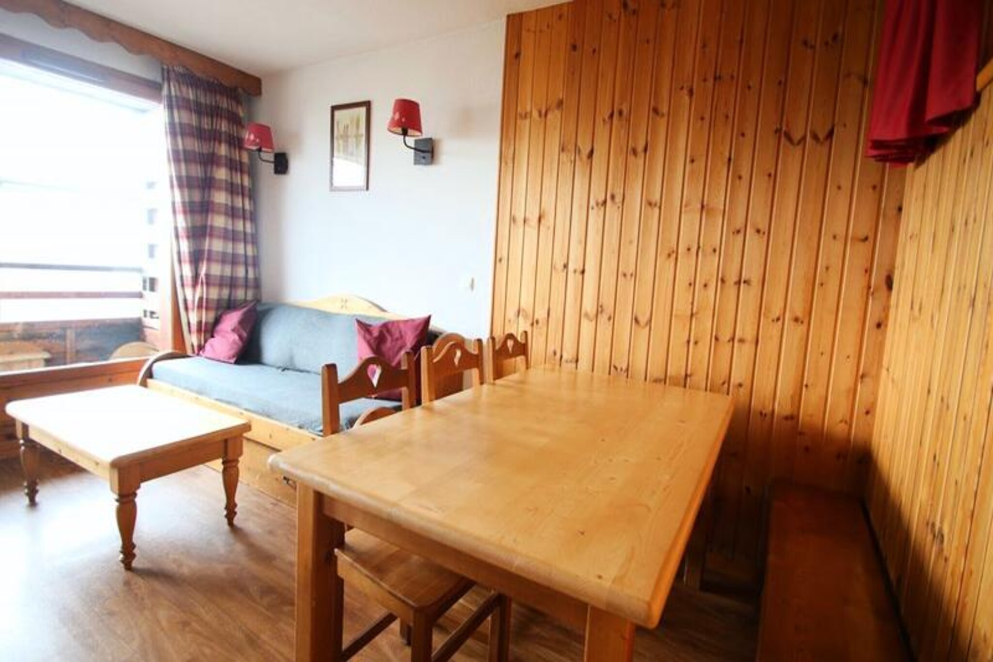 High above the picturesque slopes of Puy Saint Vincent 1800, this charming apartment invites you to experience the magic of a true alpine getaway. With breathtaking views and direct access to the ski slopes, every moment here is infused with the beauty of the French Alps. Whether you’re seeking adventure or relaxation, this residence offers the perfect balance of comfort and convenience for families and groups of up to six guests.\n\nInside, the apartment is thoughtfully designed to ensure a cozy and functional stay. The living room, complete with a pull-out sofa bed, flat-screen TV, and a balcony furnished with a table and chairs, is ideal for unwinding after a day of exploration. The well-equipped kitchen features modern appliances including a microwave, dishwasher, and ceramic hob, making it easy to prepare meals. Sleeping arrangements include a comfortable double bedroom and a cabin-style room with two single beds, all outfitted with plush duvets and pillows. A separate bathroom and WC add to the practicality of the space.\n\nThe residence itself boasts a heated outdoor pool (available in summer), a sauna, and convenient amenities such as a restaurant, snack bar, bakery, and ski equipment rental shop right at your doorstep. For added ease, WiFi is complimentary, and pets are welcome. In summer, the area transforms into a haven for hikers and nature lovers, with trails weaving through stunning alpine landscapes. Nearby attractions include the Écrins National Park and charming villages perfect for exploring local culture and cuisine.\n\nWhether you’re carving through fresh powder in winter or basking in the summer sun, this apartment is your gateway to unforgettable alpine adventures. Book now and create lasting memories in the heart of the mountains.