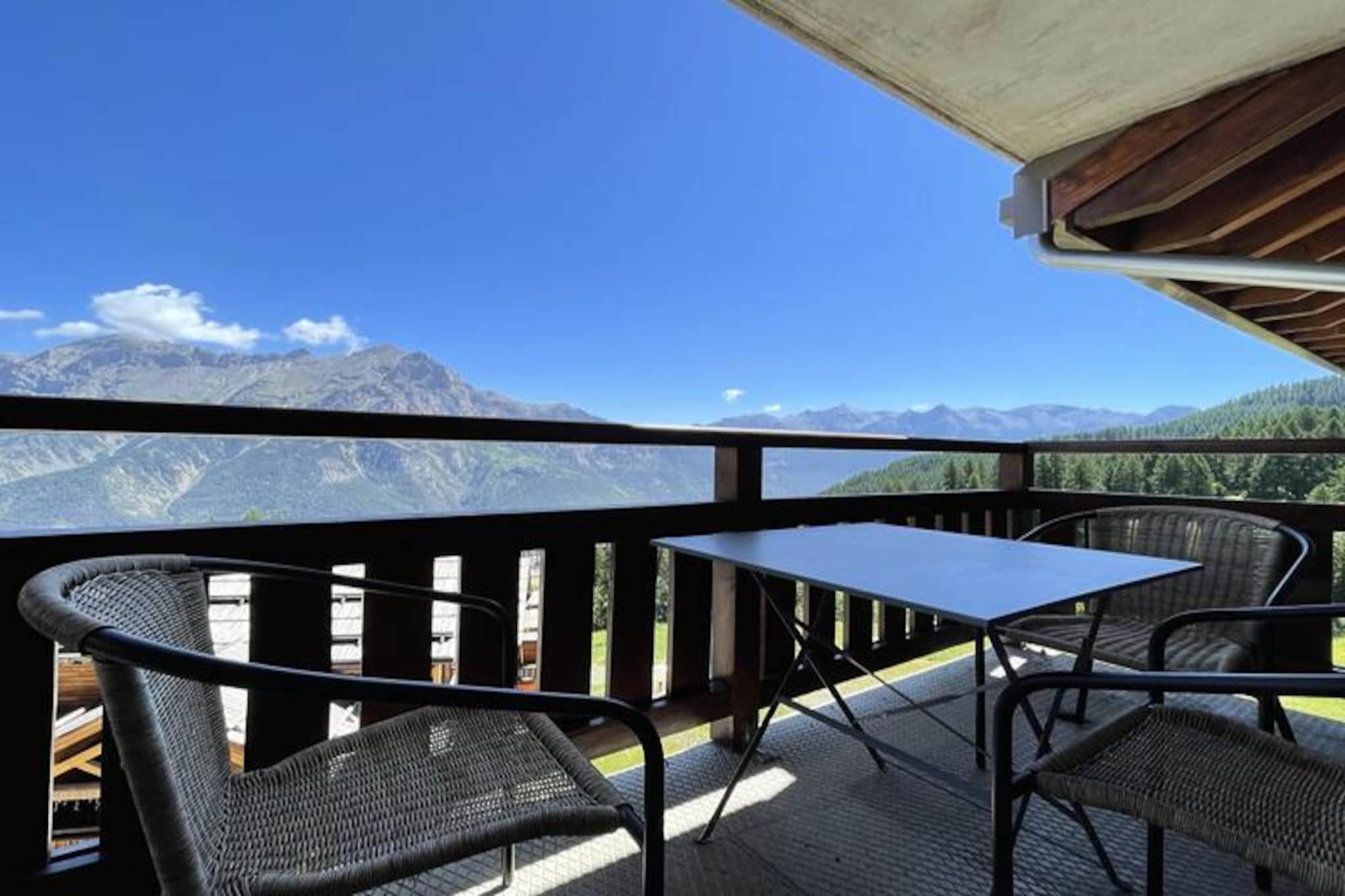High above the picturesque slopes of Puy Saint Vincent 1800, this charming apartment offers a cozy retreat for mountain lovers seeking both adventure and relaxation. With breathtaking alpine views and direct access to the ski slopes, every moment here is infused with the magic of the French Alps. Whether you're sipping coffee on the balcony or gearing up for a day on the pistes, this residence invites you to embrace the serene beauty of your surroundings. \n\nDesigned for comfort and practicality, the apartment accommodates 4-6 guests across its thoughtfully arranged spaces. The living room features a pull-out sofa bed, a dining table, and a flat-screen TV, while the balcony is furnished for enjoying fresh mountain air. The kitchen is fully equipped with modern appliances, including a microwave/grill, dishwasher, ceramic hob, and coffee machines. Sleeping arrangements include a double bedroom, a cabin room with two single beds, and a sofa bed in the living area, all with plush duvets and pillows. A bathroom with a towel warmer and a separate WC complete the layout, ensuring convenience for every guest.\n\nThe residence itself boasts exceptional amenities, including a heated outdoor pool (open in summer), a sauna, and a ski equipment rental shop. At the foot of the building, you'll find a restaurant, snack bar, and bakery offering delicious treats and basic groceries. For added convenience, a coin-operated laundromat is available on-site. Free WiFi ensures you stay connected, while optional services like linen and towel rentals make your stay hassle-free.\n\nPerfectly situated for exploring the region, this apartment is your gateway to thrilling ski adventures in winter and scenic hikes in summer. From the majestic peaks to the charming local facilities, every detail has been crafted to offer an unforgettable alpine escape. Whether you're here for the slopes or the serenity, this residence promises a holiday filled with comfort and joy.