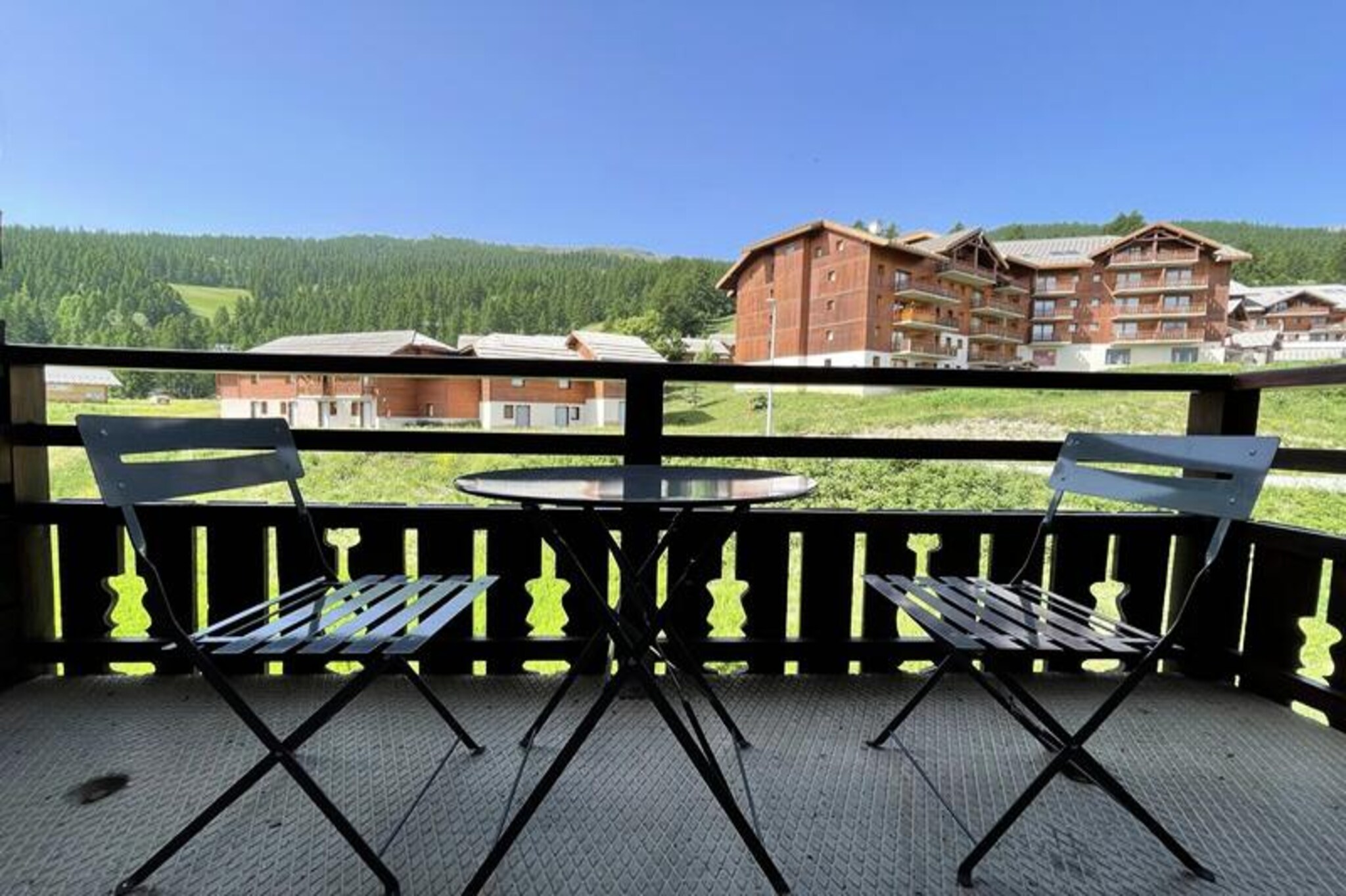 High above the serene slopes of Puy Saint Vincent 1800, this charming apartment in the La Dame Blanche residence offers an idyllic alpine escape for families and groups seeking comfort and convenience. Imagine waking up to the crisp mountain air and stepping directly onto the ski slopes from your doorstep, with breathtaking views of the surrounding peaks setting the tone for your day. Whether you're here for winter sports or summer adventures, this residence is perfectly situated to immerse you in the beauty of the French Alps. \n\nInside, the apartment is thoughtfully designed to accommodate up to six guests. The cozy living room features a pull-out sofa bed, flat-screen TV, and a balcony furnished with a table and chairs, perfect for enjoying a morning coffee or evening glass of wine. The well-equipped kitchen includes modern appliances such as a microwave, dishwasher, and ceramic hob, ensuring you have everything needed to prepare delicious meals. Sleeping arrangements include a double bedroom, a cabin room with two single beds, and additional bedding in the living area, all outfitted with fresh duvets and pillows for a restful night's sleep. \n\nThe residence itself boasts fantastic amenities, including a heated outdoor pool open during the summer months, a sauna available for private reservation, and convenient on-site facilities like a ski rental shop, bakery, and snack bar. Nearby, you'll find grocery essentials and a restaurant to satisfy your cravings after a day of exploration. For added convenience, WiFi is complimentary, and covered parking is available for rent. \n\nWhether you're carving through pristine snow in winter or hiking lush trails in summer, this property offers a seamless blend of relaxation and adventure. With its prime location and thoughtful amenities, La Dame Blanche invites you to create unforgettable memories in the heart of the Alps.