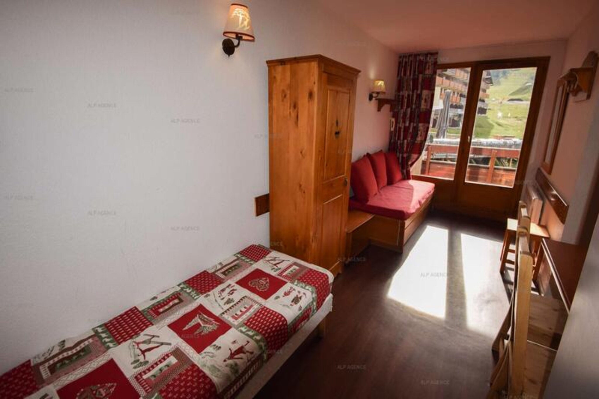 High above the snowy peaks of the French Alps, this cozy apartment in the Le Cervin residence offers a perfect retreat for ski enthusiasts and nature lovers alike. Located in Plagne Soleil, the property boasts an unbeatable location at the foot of the slopes, with all essential shops conveniently situated right below the building. Whether you're here for thrilling winter sports or serene summer hikes, this charming getaway promises unforgettable moments in the heart of the mountains.\n\nThe apartment, designed to accommodate up to five guests, features a thoughtful layout with a south-facing balcony that invites you to soak in the alpine sunshine. Inside, you'll find a well-equipped kitchen with a ceramic hob, refrigerator, microwave, and dishwasher, making meal preparation a breeze. The living area includes a dining space, a TV, and comfortable pull-out beds, while the separate bedroom offers two single beds for restful nights. Additional amenities such as a ski locker, WiFi, and a bathtub ensure both convenience and relaxation during your stay.\n\nPlagne Soleil is seamlessly connected to Plagne Villages and Plagne Centre via shuttle buses and gondolas, making it easy to explore the wider area. From exhilarating ski runs to scenic trails, the region offers endless opportunities for outdoor adventure. After a day of activity, unwind with local Savoyard cuisine at nearby restaurants or browse the shops for unique alpine souvenirs.\n\nWhether you're seeking adrenaline-pumping slopes or tranquil mountain vistas, this apartment provides the perfect base for your alpine escape. With its prime location and welcoming ambiance, it’s an ideal choice for families, couples, or small groups looking to immerse themselves in the beauty of the French Alps.