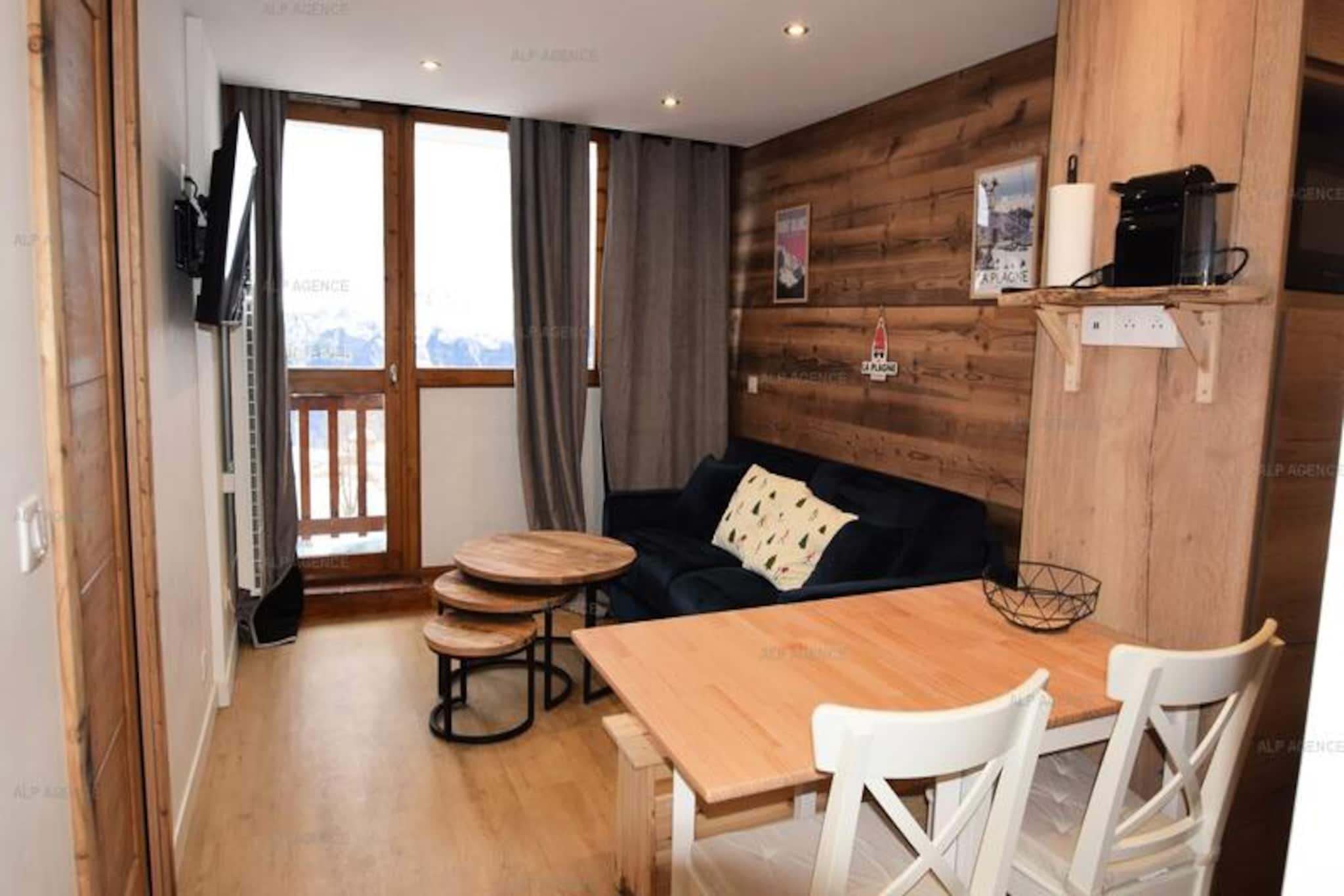 High above the Tarentaise Valley, this charming studio apartment in Les Aollets Residence offers a serene alpine escape with direct access to the slopes. Imagine waking up to crisp mountain air and stunning views of Dou du Praz from your two private balconies, before stepping outside to ski straight onto the piste. Located in the heart of Plagne Villages, this quiet, five-story residence is just 50 meters from shops and restaurants, making it an ideal base for both adventure and relaxation. The free cable car and bus connection to Plagne Centre ensure easy access to the wider resort area, adding convenience to your stay. \n\nCompletely renovated in autumn 2024, the apartment combines modern comfort with cozy charm. The 26m² studio accommodates up to five guests, featuring a sleeping alcove with bunk beds and a pull-out bed, and a living area with a comfortable sofa bed. The fully equipped kitchen includes ceramic hobs, a combination oven, dishwasher, and Nespresso machine, perfect for preparing meals after a day on the slopes. Additional amenities such as a connected flat-screen TV, WiFi, and a washing machine ensure a hassle-free stay. The apartment is non-smoking and pet-free, maintaining a clean and welcoming environment. \n\nStep outside and you’ll find everything you need within easy reach. The ski school meeting point is nearby, along with a variety of shops and dining options. Free outdoor parking is available, and preferential rates for ski passes make it easy to explore the world-class Paradiski domain. In summer, the area transforms into a haven for hikers and mountain bikers, with breathtaking trails and panoramic views. \n\nWhether you’re seeking thrilling winter sports or tranquil summer adventures, this beautifully located apartment offers the perfect blend of comfort, convenience, and alpine charm. Create unforgettable memories in the heart of the French Alps.