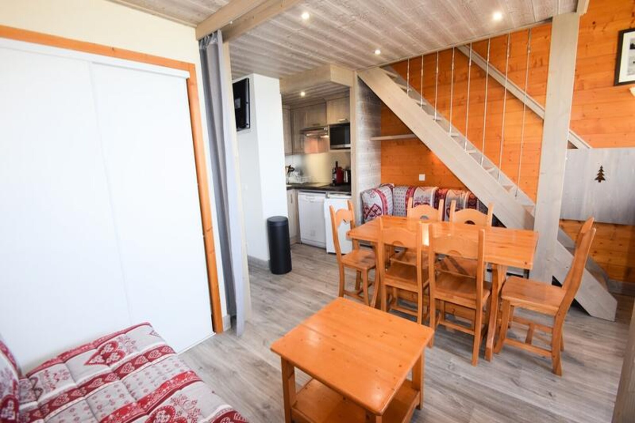High above the picturesque Tarentaise Valley, this beautifully renovated duplex apartment in Les Aollets Residence offers a serene alpine retreat with direct access to the slopes of Plagne Villages. Imagine waking up to breathtaking views of the valley from your north-facing balcony, sipping coffee as the crisp mountain air fills your lungs. Perfectly situated just 50 meters from local shops and connected to Plagne Centre by free cable car or bus, this residence combines tranquility with convenience for an unforgettable getaway in the French Alps. \n\nDesigned with comfort and charm in mind, this 3-room apartment spans 50m² and accommodates up to six guests. The American-style kitchen is fully equipped with ceramic hobs, a refrigerator, microwave oven grill, dishwasher, and Nespresso coffee machine, making meal preparation a delight. The living room, which can be divided by a curtain, features a dining area and a cozy lounge with pull-out beds. Upstairs, the mezzanine offers two single beds, while the second bedroom boasts a comfortable double bed. With two bathrooms, including a bathtub and shower, and thoughtful touches like safety gates on the stairs, this non-smoking apartment is ideal for families seeking a peaceful yet practical holiday home. \n\nStep outside to explore the pristine slopes directly accessible from the ski locker, or enjoy the convenience of nearby shops and free outdoor parking. In winter, the residence is a gateway to thrilling ski adventures, while summer transforms the region into a haven for hiking, cycling, and exploring the stunning alpine landscapes. Whether you're seeking adrenaline-pumping activities or quiet moments surrounded by nature, this charming apartment offers the perfect base for your alpine escape. \n\nWith its unbeatable location, modern amenities, and cozy ambiance, this residence invites you to create lasting memories in the heart of the Paradiski domain. Book your stay today and experience the magic of Plagne Villages for yourself.