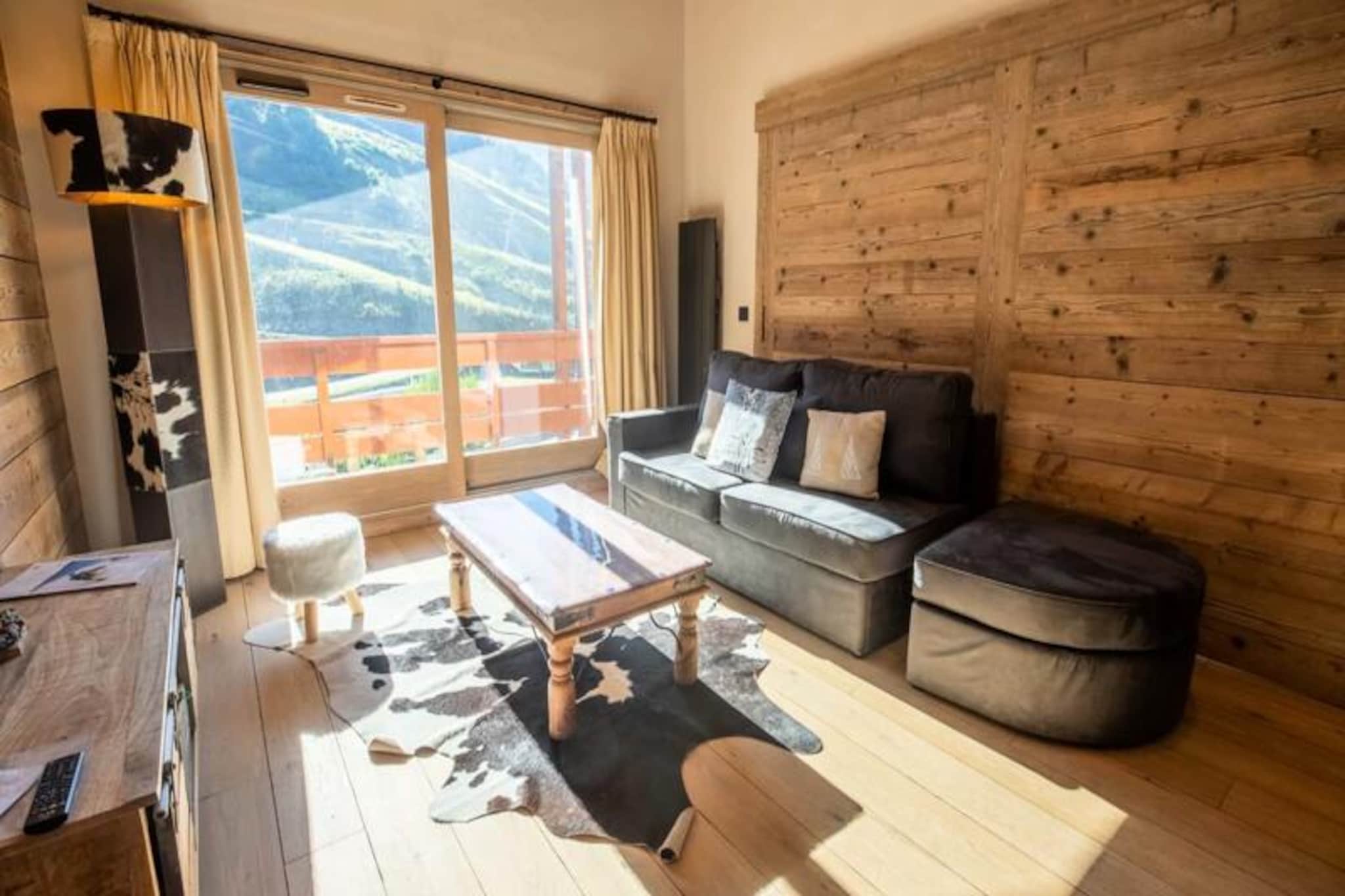 High above the enchanting Méribel Mottaret, this stunning penthouse apartment offers an unparalleled alpine retreat for up to eight guests. Bathed in sunlight and surrounded by breathtaking mountain views, this luxurious duplex combines the rustic charm of the Alps with modern sophistication, creating an unforgettable setting for your ski holiday. Located just steps from the slopes in the Châtelet district, it’s the perfect base for exploring the world-renowned 3 Valleys ski area. 
 
 Inside, the apartment boasts a fully renovated interior with elegant finishes and thoughtful design. The open-plan kitchen, equipped with top-of-the-line appliances, flows seamlessly into a spacious living area with soaring ceilings and a large bay window that floods the space with natural light. A second living room, which can be converted into a bedroom with a plush 160cm sofa bed, offers additional comfort and flexibility. The master bedroom, featuring a luxurious 160cm bed, opens onto a south-facing terrace where you can soak in panoramic mountain views. Additional sleeping arrangements include a cozy bunk room and a mezzanine bedroom with its own en-suite bathroom, complete with a whirlpool tub. A second bathroom with a shower and separate toilet ensures convenience for all guests.
 
 After a day on the slopes, unwind in the spa or enjoy a meal prepared with the raclette and fondue sets provided. Modern amenities such as Wi-Fi, a private garage, a ski locker, and a washing machine ensure a hassle-free stay. Additional services, including ski pass delivery, equipment rental discounts, and private chef options, are available to enhance your experience.
 
 Located less than 100 meters from the slopes, the apartment offers unbeatable ski-in/ski-out access. A mini-market at the foot of the building provides fresh pastries and essentials, while nearby slope-side restaurants invite you to savor local flavors. The free shuttle bus, stopping just outside, makes it easy to explore the valley. Whether you’re here for the thrill of skiing or the serenity of the mountains, this penthouse promises a truly magical getaway.