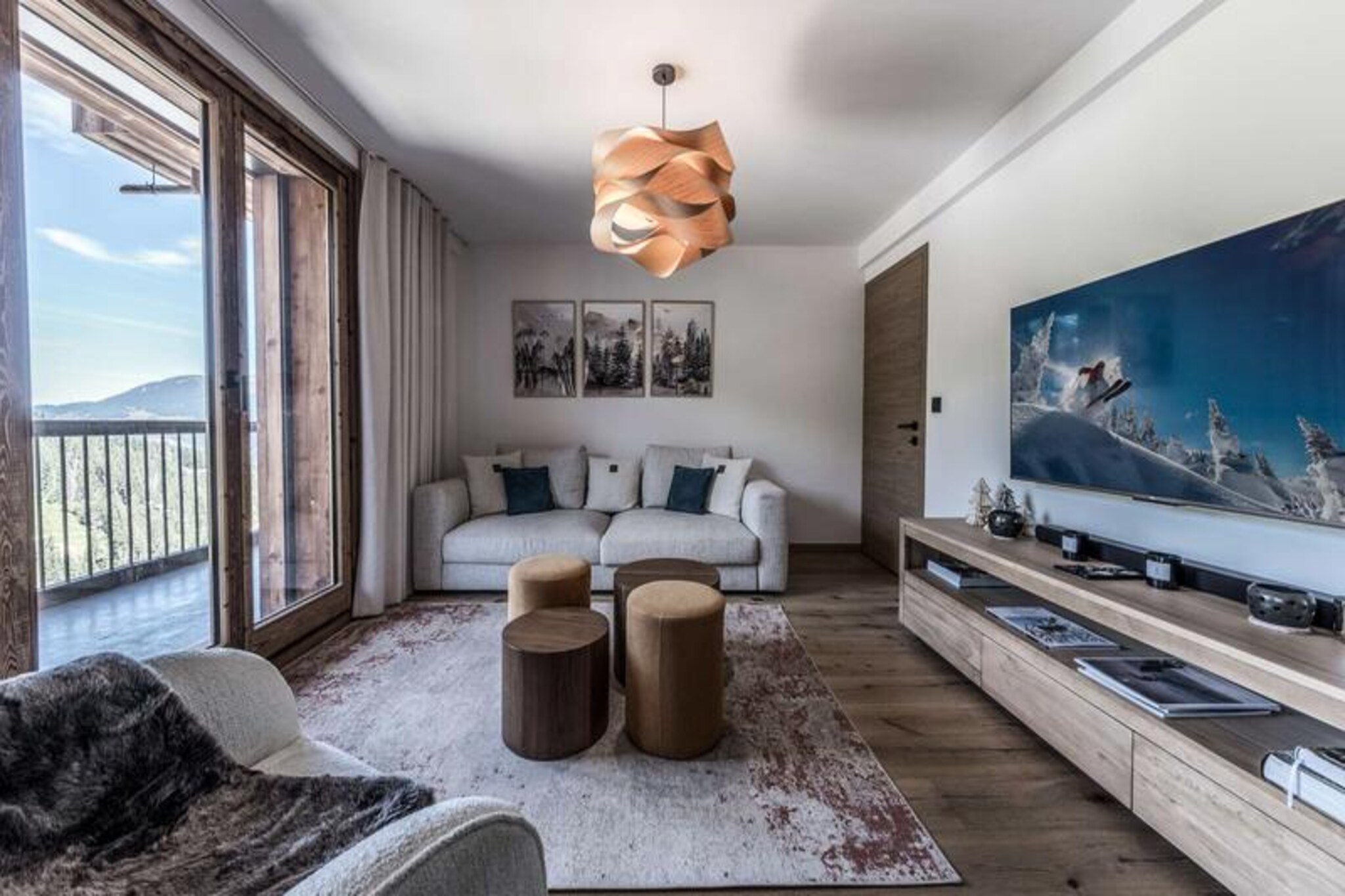 High above the picturesque slopes of Courchevel 1650, this luxurious and contemporary apartment offers an unparalleled alpine retreat. Imagine waking up to the breathtaking views of snow-capped peaks and the serene valley below, all from the comfort of your private balcony. Whether you're here for the thrill of skiing or the tranquility of mountain living, this ski-in/ski-out haven promises an unforgettable escape.
Spanning an impressive 95 square meters, the apartment comfortably accommodates up to eight guests. The living and dining area, bathed in natural light, invites you to relax with its plush furnishings and modern décor. The fully equipped kitchen, featuring top-of-the-line appliances like a L'Or Barista coffee machine and a wine cellar, ensures every meal is a delight. The bedrooms are designed for ultimate comfort, including a master suite with an en-suite bathroom and balcony, a second queen-size bedroom, and a versatile third room that can be configured with four single beds or two doubles. Indulge in the whirlpool tub after a day on the slopes, and enjoy the convenience of a washer/dryer, ski locker, and covered parking space.
The location is unbeatable, with the Petit Moriond gondola lift just steps away and the Ariondaz slope bringing you back to your doorstep. Local shops, including a delicatessen and ski rental, are conveniently located at the foot of the residence. Beyond skiing, the vibrant town center offers a variety of restaurants, boutiques, and après-ski activities to complete your alpine experience.
With personalized concierge services, including ski pass bookings, restaurant reservations, and transfer arrangements, every detail of your stay is taken care of. Whether you're visiting in winter for the pristine slopes or in summer for the lush mountain trails, this apartment is your gateway to the best of Courchevel 1650.