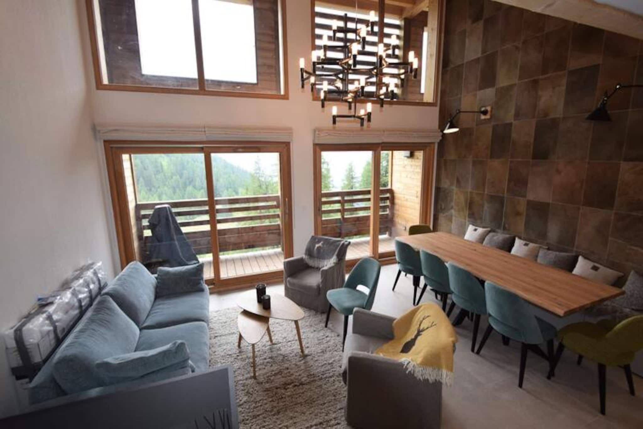 High above the snowy slopes of La Plagne, this luxurious duplex apartment invites you to experience the charm of the French Alps in style. With breathtaking views of Mont Blanc from your private balcony, every moment here feels like a postcard come to life. Whether you're sipping coffee as the sun rises over the peaks or unwinding after a day on the slopes, this residence offers an unparalleled alpine retreat just 200 meters from ski access. Perfect for families or groups, it combines modern elegance with the warmth of a mountain escape. \n\nSpanning 115m², this 3-star, 5-Crystal Paradiski-rated apartment is thoughtfully designed to accommodate up to 10 guests. The ground floor features a fully equipped kitchen with induction hobs, an oven, microwave, refrigerator/freezer, and dishwasher, alongside a spacious dining and lounge area with a large table and TV. Upstairs, four beautifully appointed bedrooms offer a mix of double beds, queen-size beds, and bunk beds, ensuring comfort for all. The master suite boasts a private balcony, TV, and bathtub, while other rooms include separate showers and toilets. Additional amenities like a washing machine, dryer, cot, and high chair ensure a seamless stay. \n\nConvenience is key, with a private ski room featuring a boot dryer and ski locker, plus two covered parking spaces equipped with an electric car charging point. Optional extras like end-of-stay cleaning, bed linen, and ski passes make your holiday stress-free. Beyond the apartment, La Plagne Centre offers vibrant après-ski options, cozy restaurants, and shops, all within easy reach. In summer, the region transforms into a haven for hikers and cyclists, with trails that wind through lush alpine meadows and stunning vistas. \n\nWhether you're seeking thrilling winter adventures or tranquil summer escapes, this residence is your gateway to unforgettable memories in the heart of the Alps.